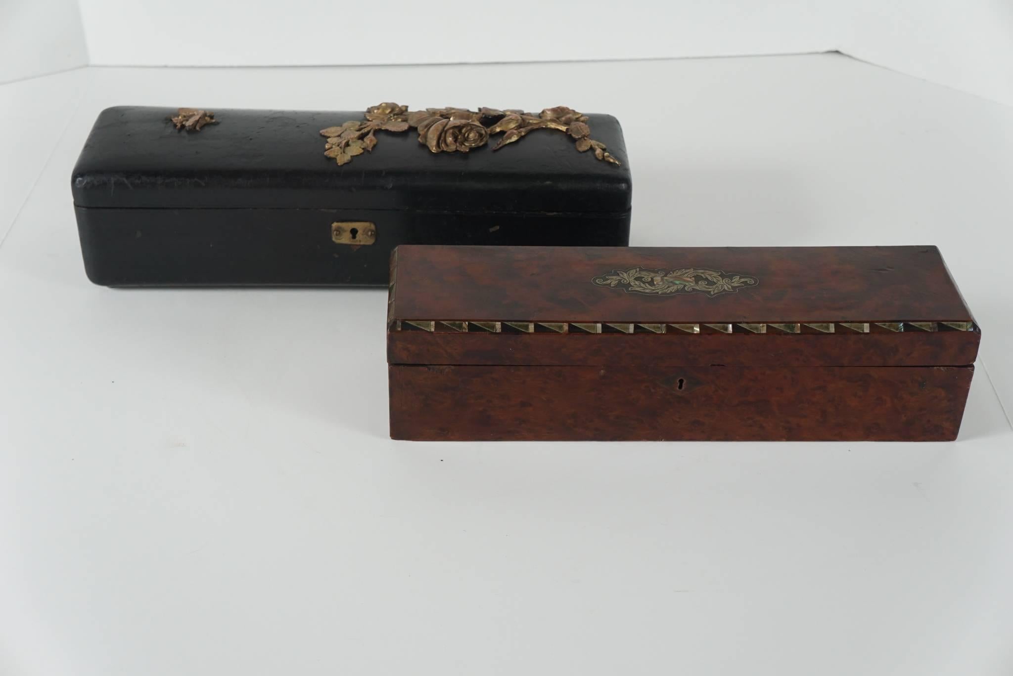 These two boxes from a private New York collection are fine examples of a necessary item in a 19th century women's home. The larger box is in black leather with gilt metal applied roses and stems and is marked with the makers label and address. The
