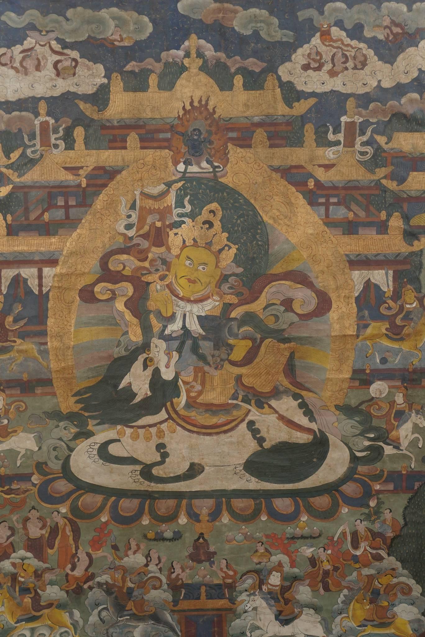 This fine vintage painted work is richly filled with small figures surrounding a large central figure. All interspersed with clouds and religious symbols. The colors are deep but muted with time and age. The piece is newly bordered in rich Chinese