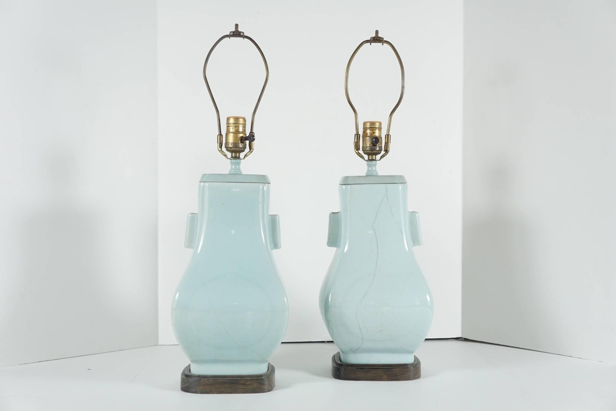 This fine pair of vases of archaistic square baluster form mounted as lamps comes from Hyde Park Antiques and were purchased in the 1960s. The porcelain is of fine quality and heavily molded. The crackled glaze is deep and largely patterned and is