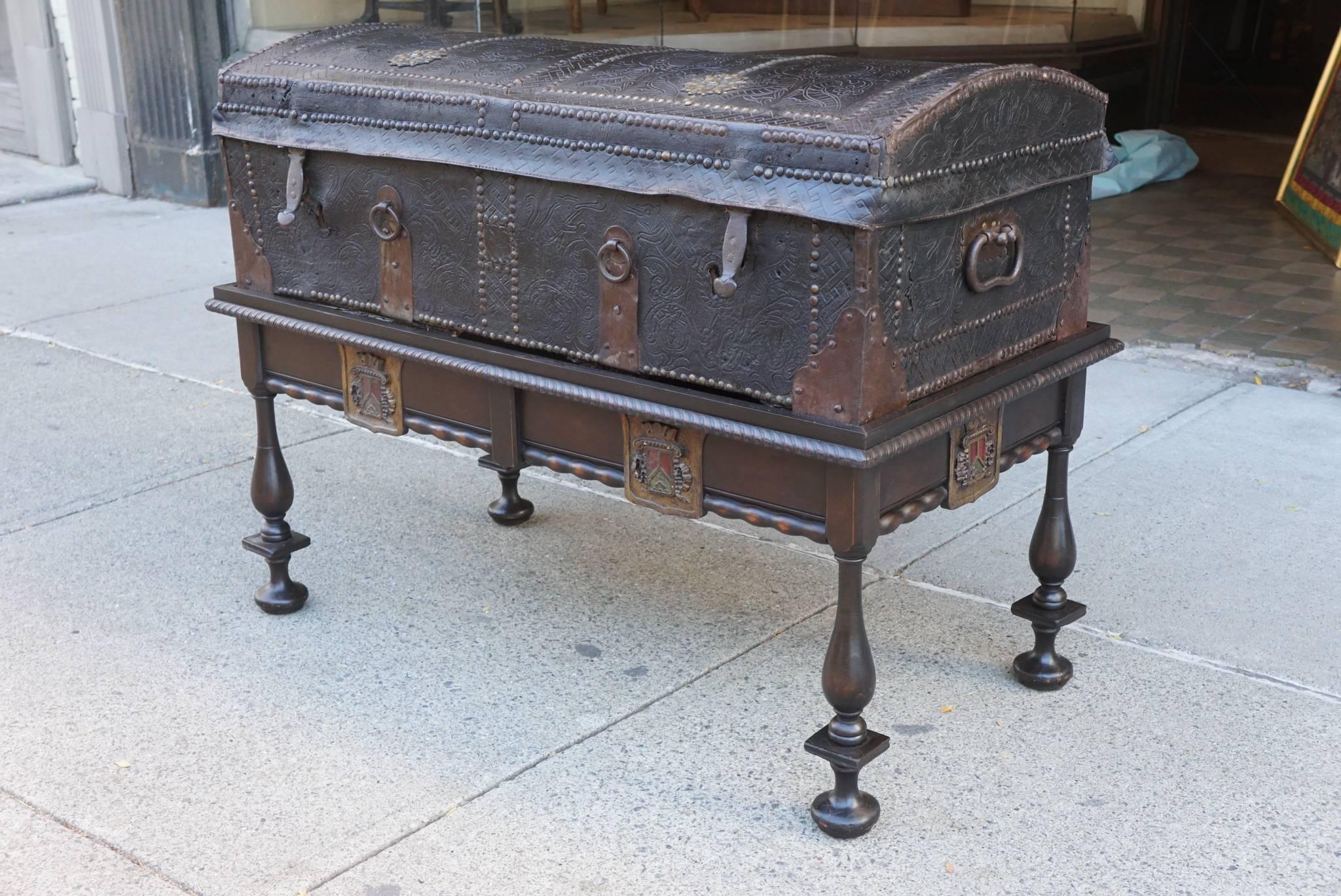 This interesting period trunk, circa 1680-1700 is constructed of wood that has been banded in iron then covered with embossed leather and brass tacks and spandrels creating a decorative and strong travel box for a gentleman’s possessions. The trunks
