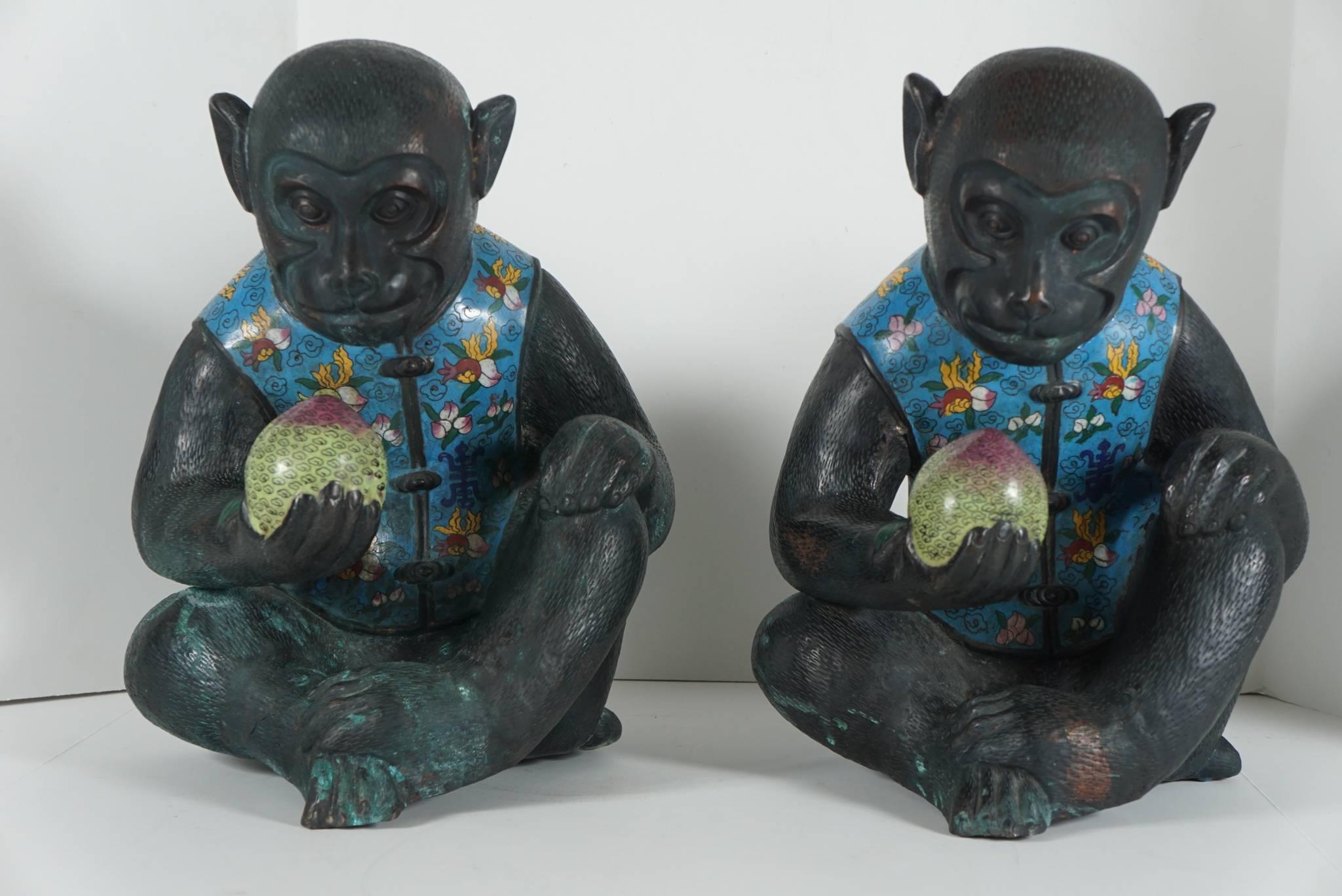 These lovely large-scale figures are dressed in richly patterned blue cloisonne vests and hold a peach in yellow cloisonne enamels, circa 1920-1930. The bodies of the monkeys are repousse copper with many fine details worked from the inside and