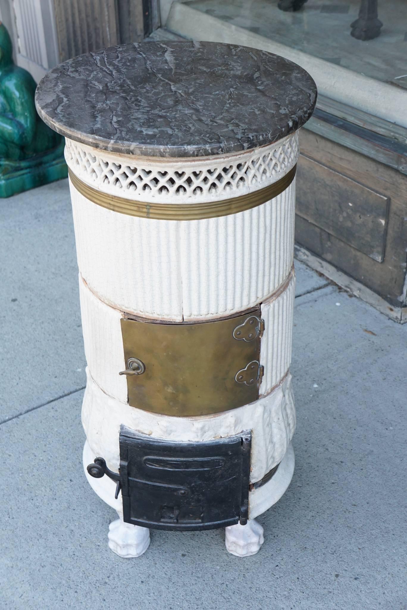 This lovely old heating stove comes from Oak Springs Farm, Bunny Mellon's estate in Virginia. Made in Sweden, circa 1790 to circa 1810 the stove has been reduced in size thru the years and now serves as a lovely pedestal or plant stand. Crafted of