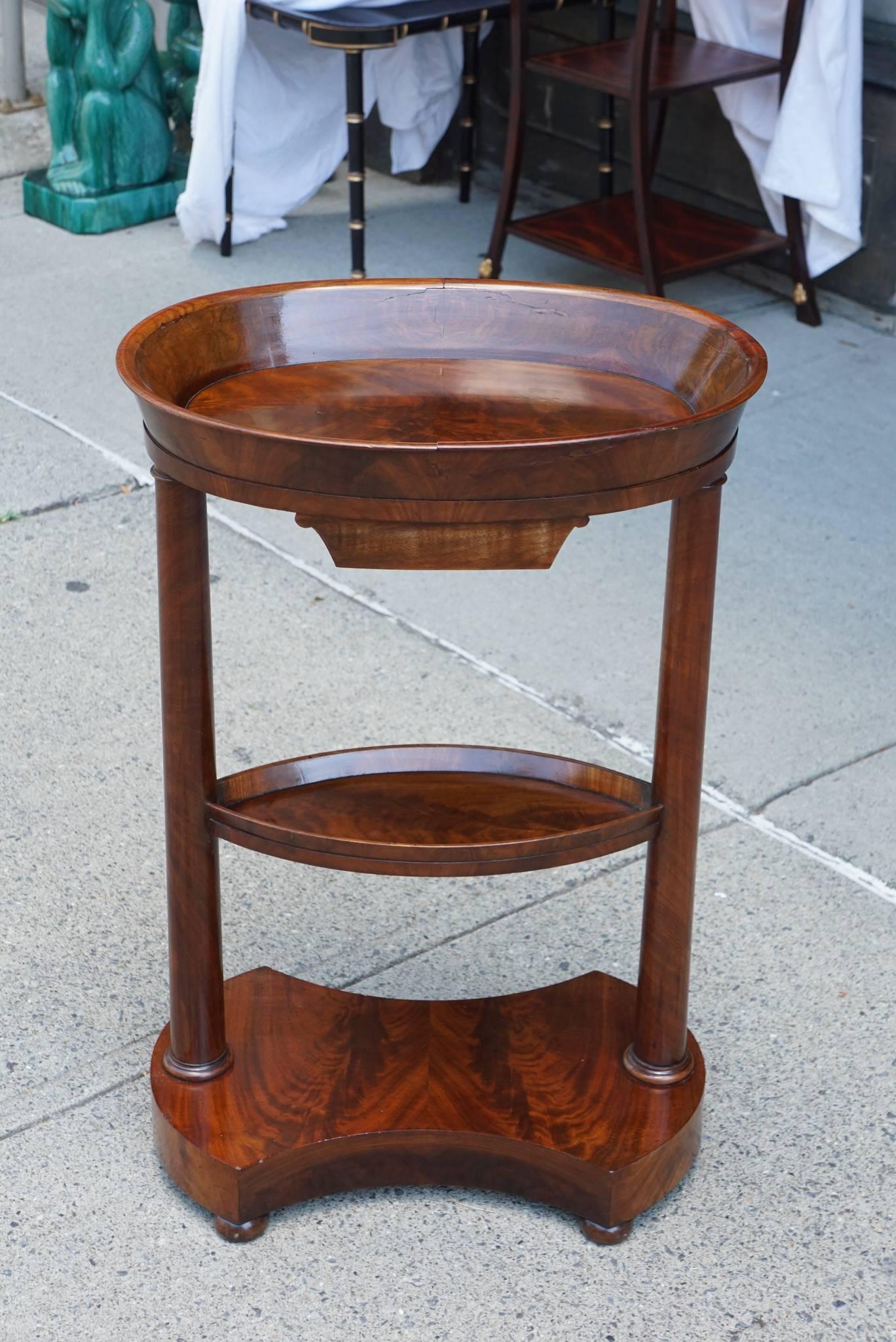 This table made in expensive imported mahogany was made in France, circa 1820. Stylish in an Empire form but in a then new easy less formulaic way showing the end of the countries need to dominate the continent. It's light airy form is playful with