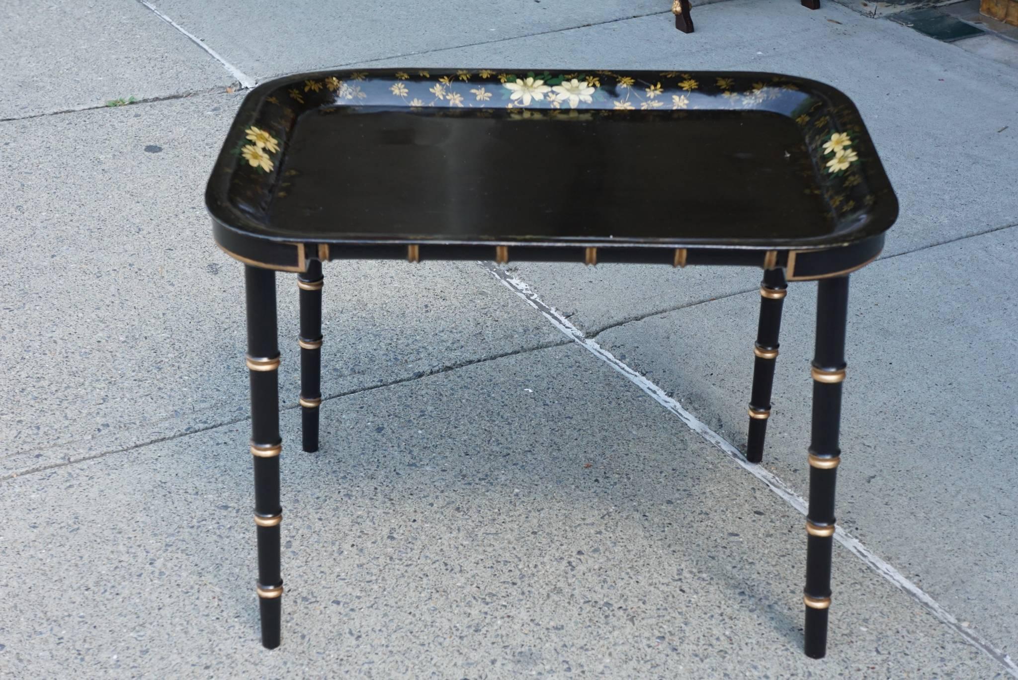 The tole tray painted in America, circa 1850 is sweet and charming showing sprays of Daisies amidst vining flowers and leaves. Painted in warm yellows and whites on a black ground the greens of the leaves and fresh flowers pop off the shiny black.