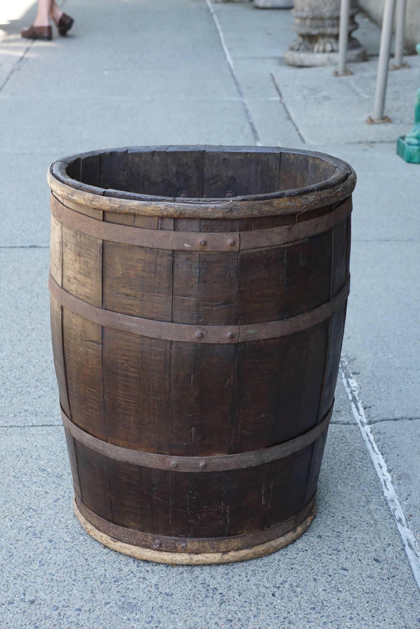 This French work barrel for champagne grapes comes from an old Kinderhook, early 18th century stone house in Upstate New York. Made circa 1860-1870 the oak staves are bound in iron and the barrel has a large iron handle at the back. This form would
