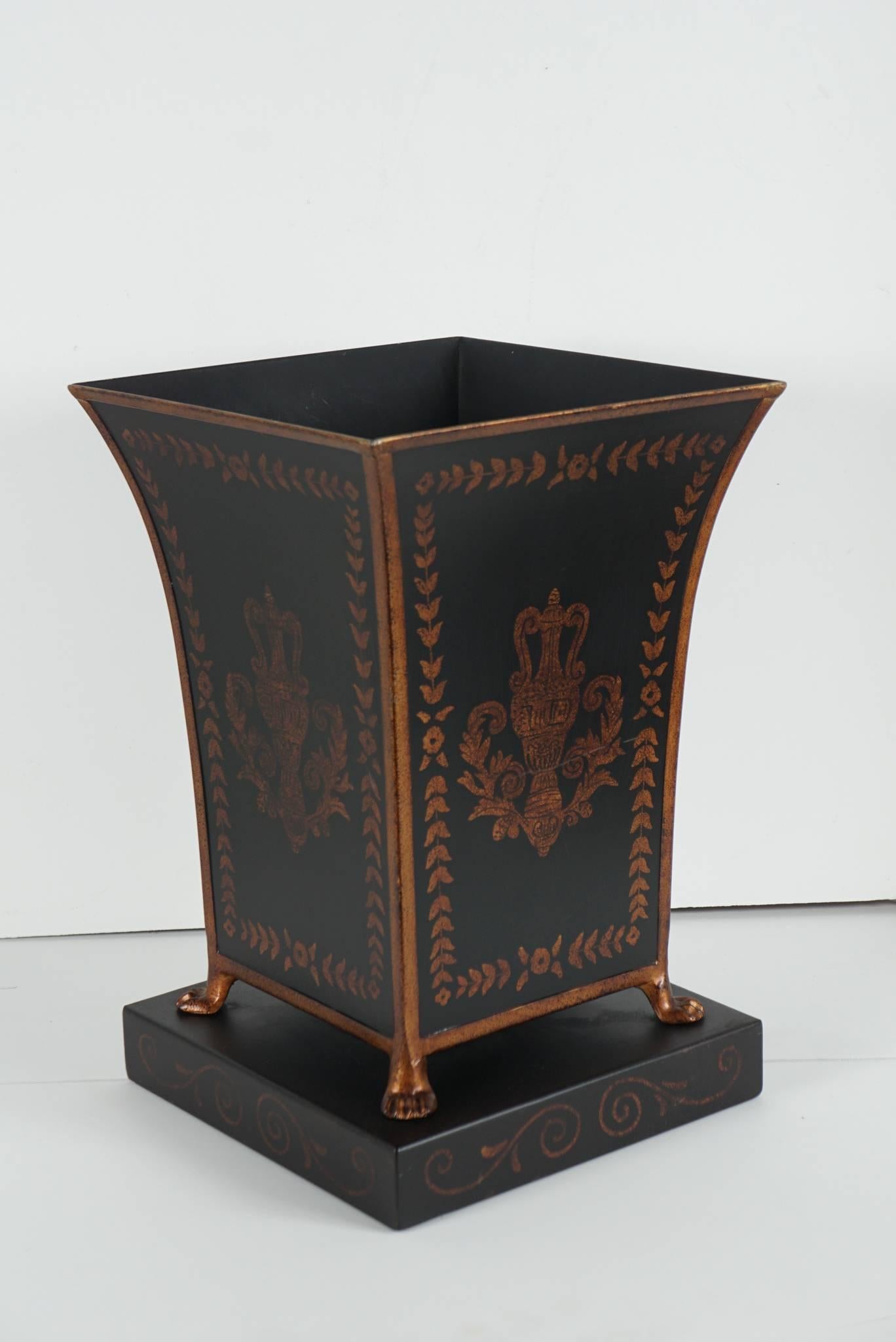 These two different objects were used as waste paper baskets by the Mellons in their home Oak Spring Farms. One is a tole large flower vase on base and is painted in black with tortoiseshell gilded decorations of medallions and leaf borders similar