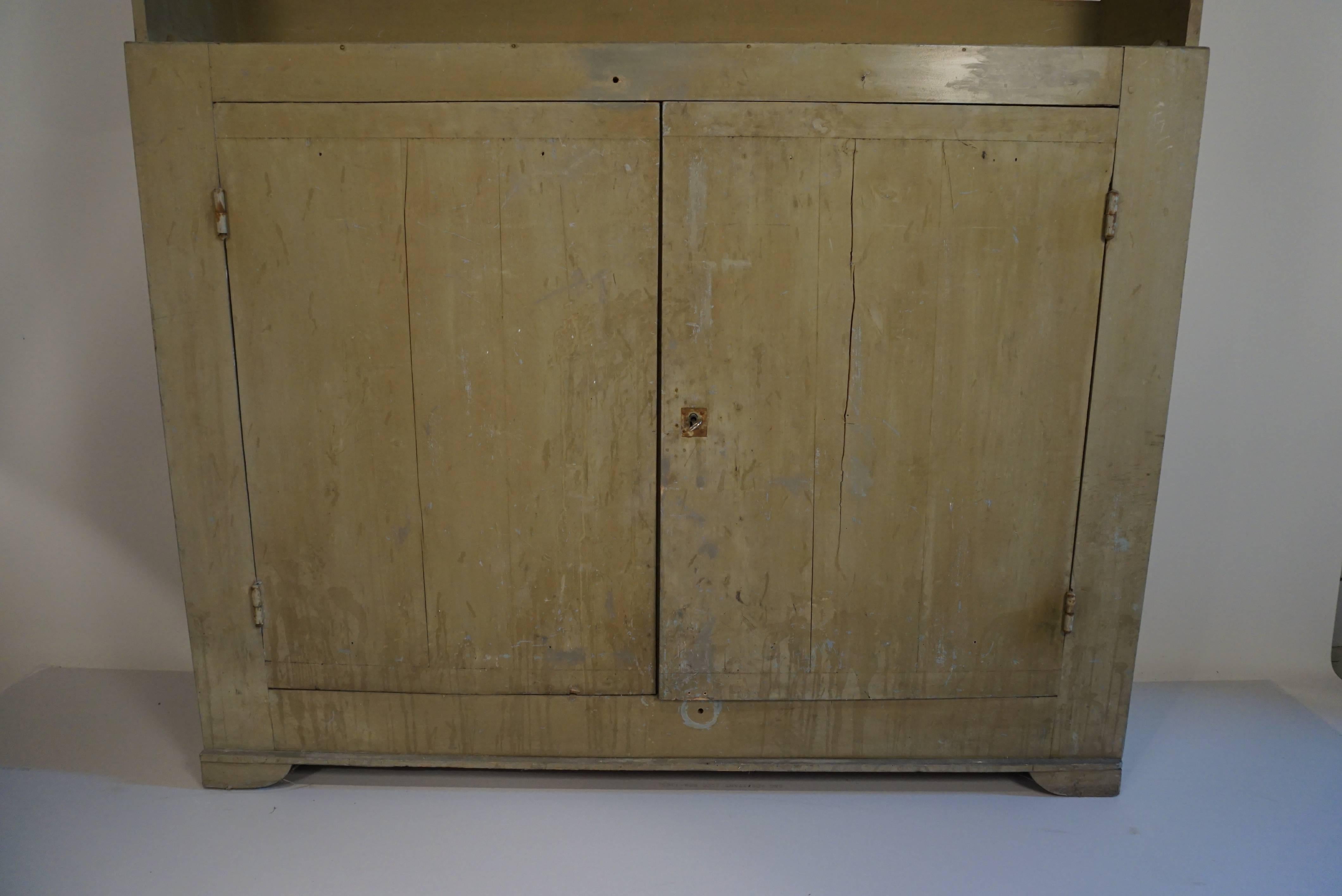 An unusual form with a long top board creating a winged effect.
Beautiful pale green paint.
Wonderful for storage and display.
Width of cupboard (excluding top) is 57 inches.