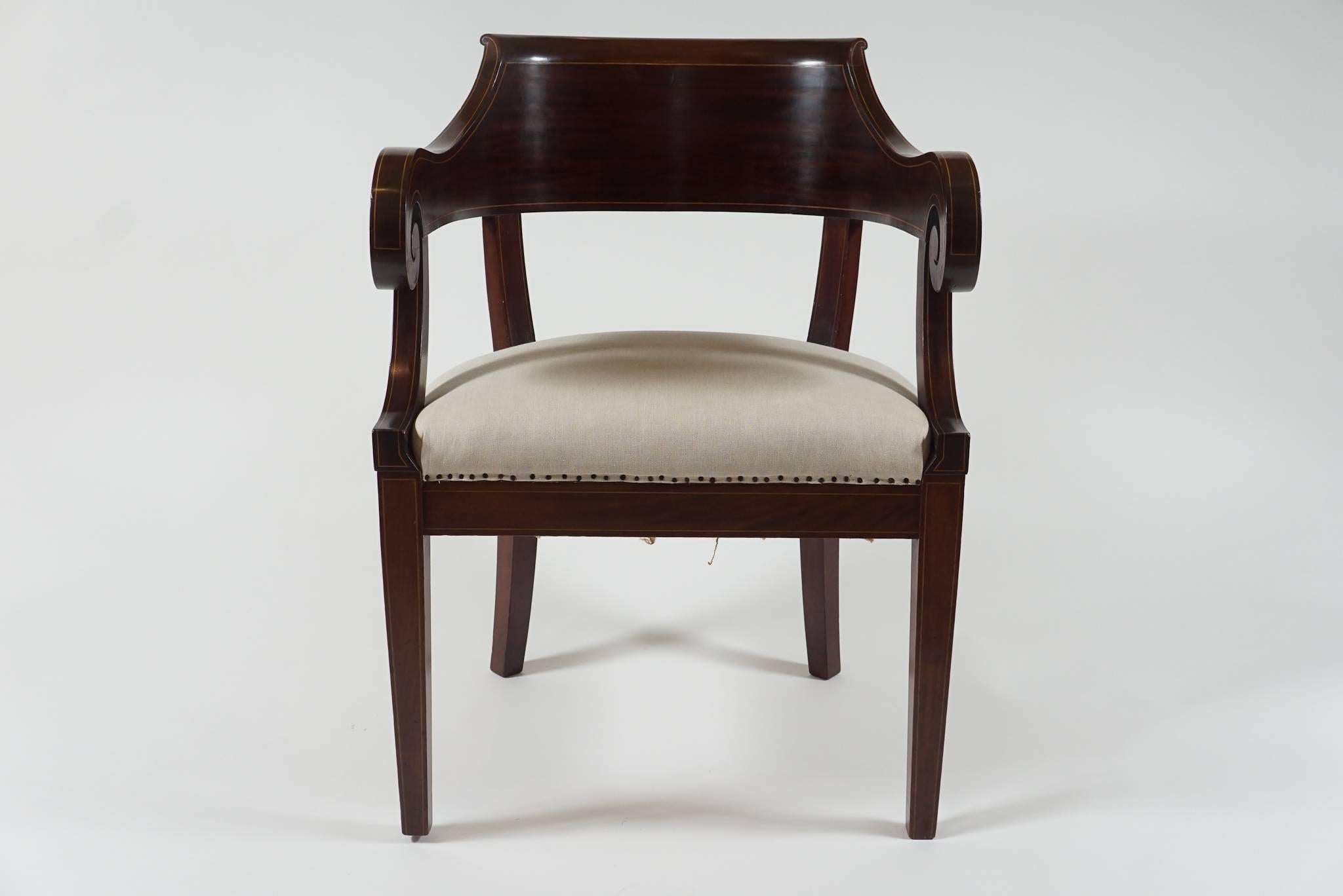 A prime example of the American Classical style.
This mahogany armchair has detailed inlay and old form.