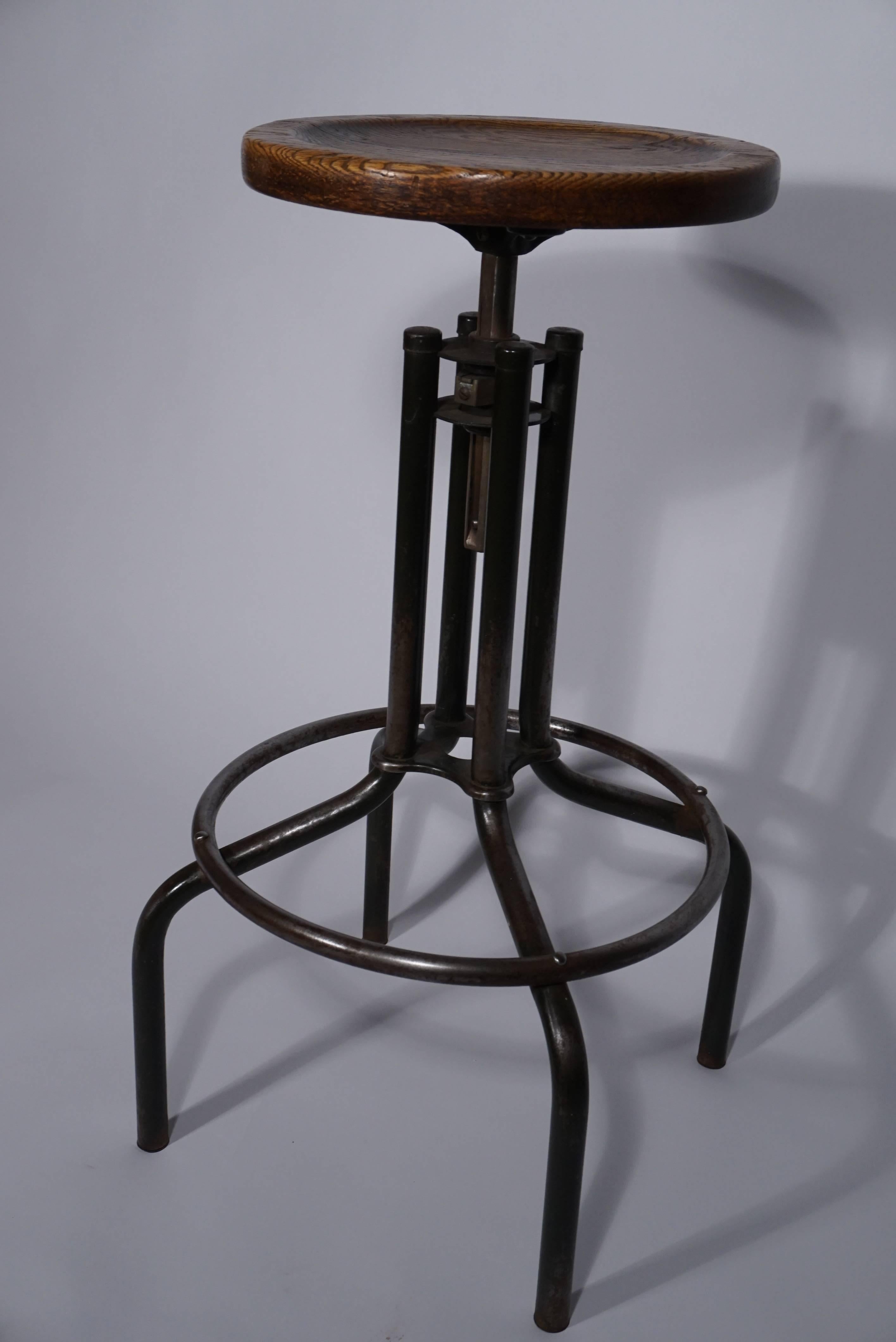 Industrial stool with adjustable oak seat. Seat heights adjust from 30 inches to 35 inches.