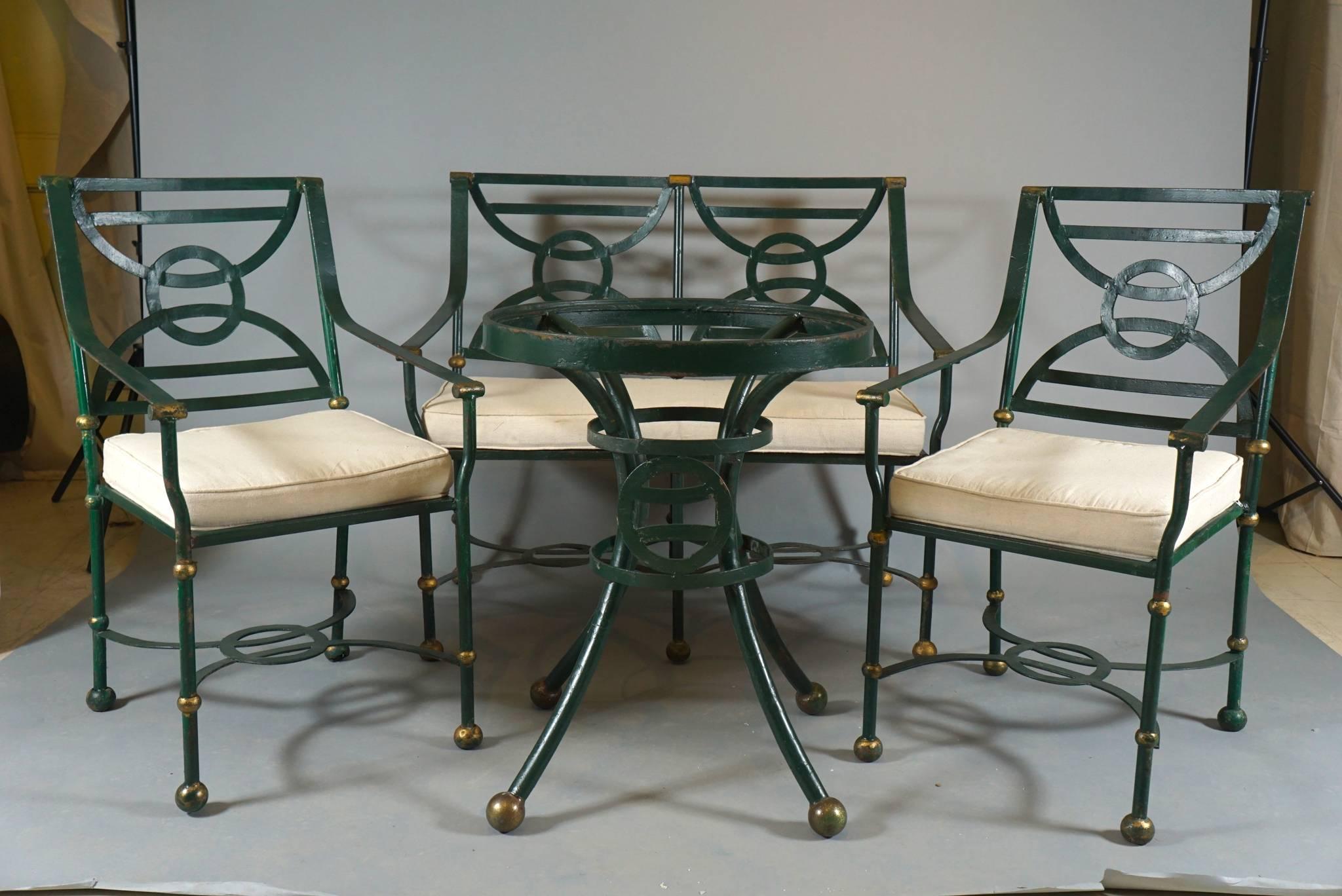 Four-piece set of iron garden furniture classical motif. bench, two armchairs and table with glass top
handcrafted iron with paint and gilt details.