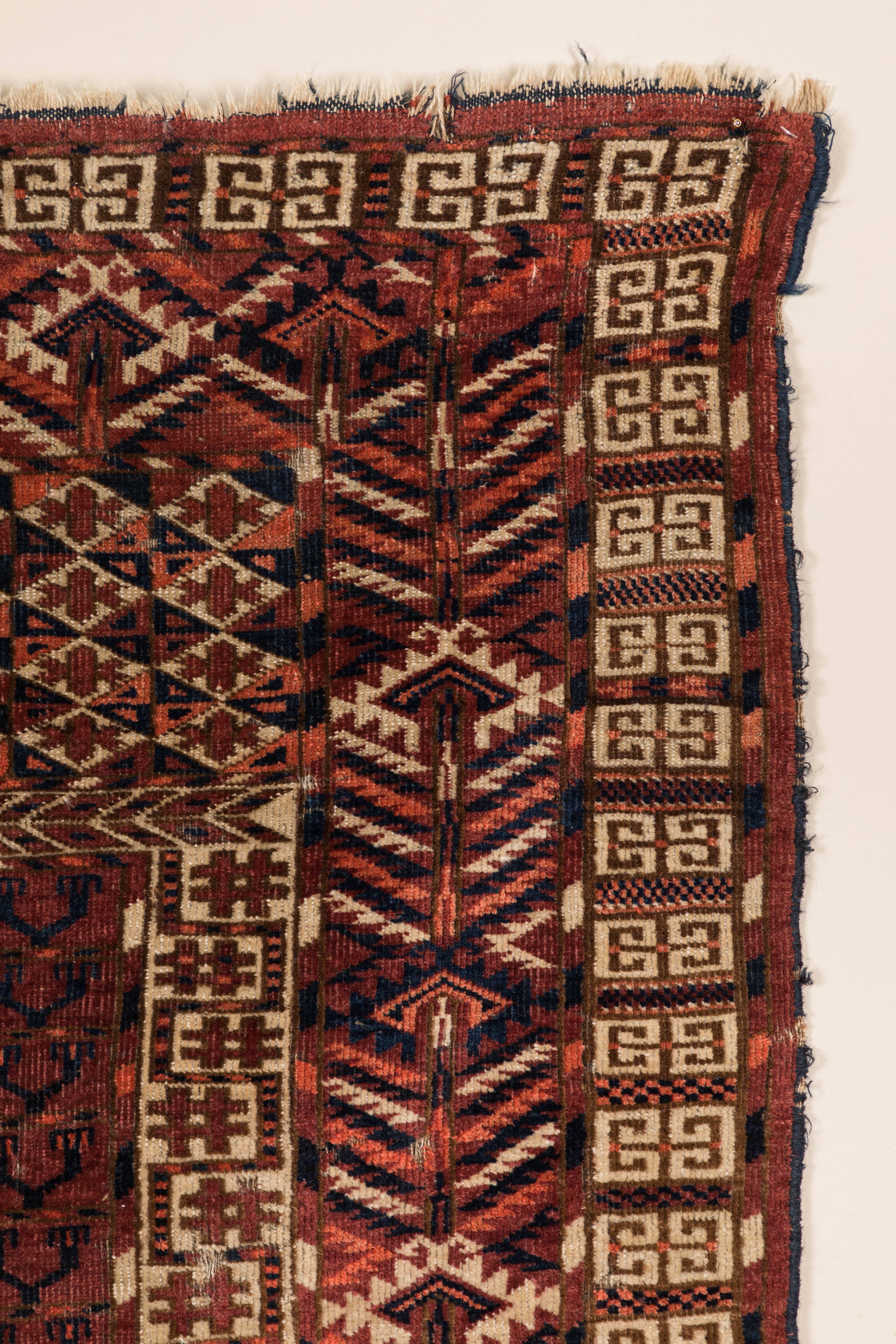 Early 20th century hand-knotted, wool pile tribal rug. Low pile. Few minor repairs and minor damage at end.  Offered by .  