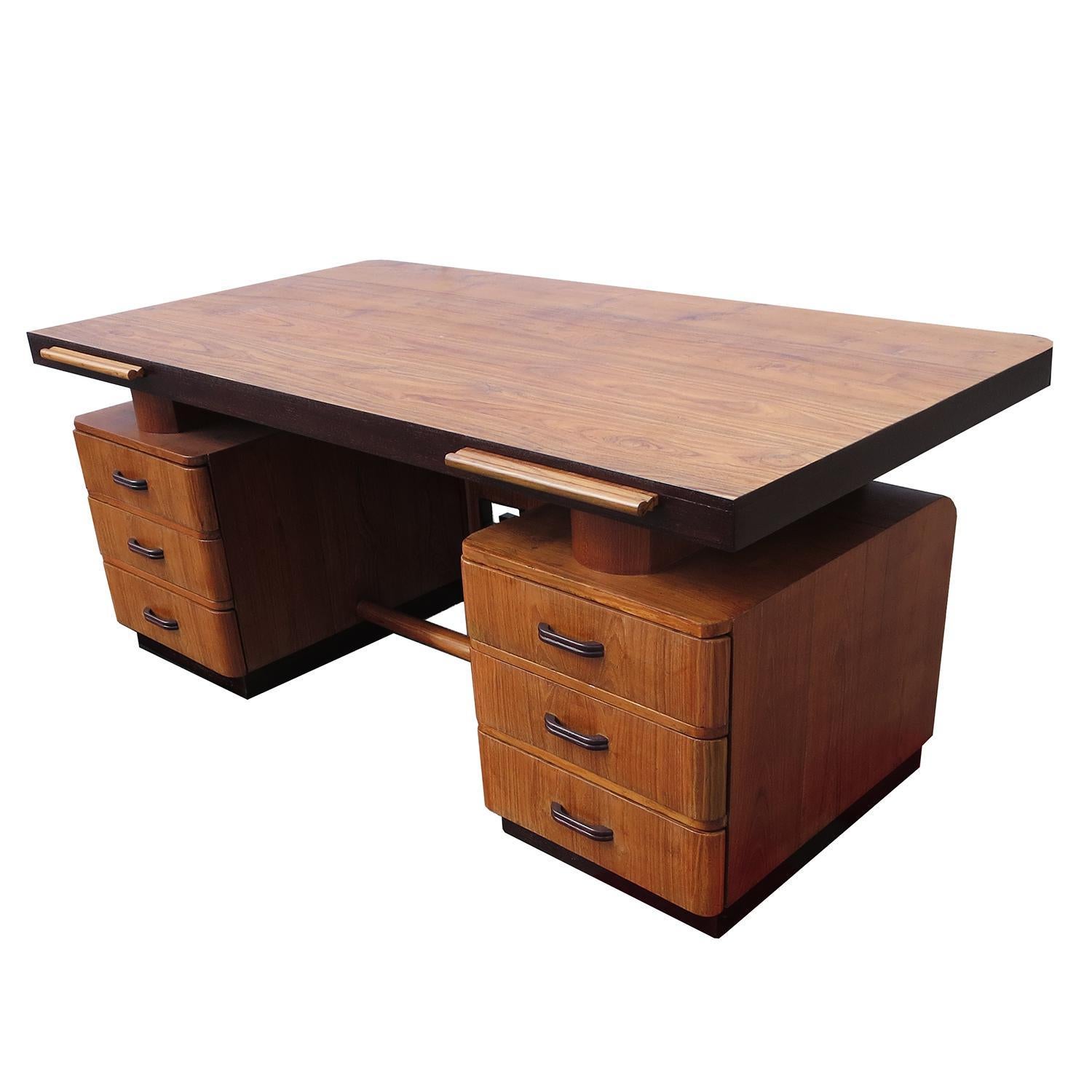 This stylized desk features curved corners and a unique grille in the front center. The expansive top surface seems to float over the top. There are three drawers and pullout / pull-out writing surfaces on each side, for ample storage and