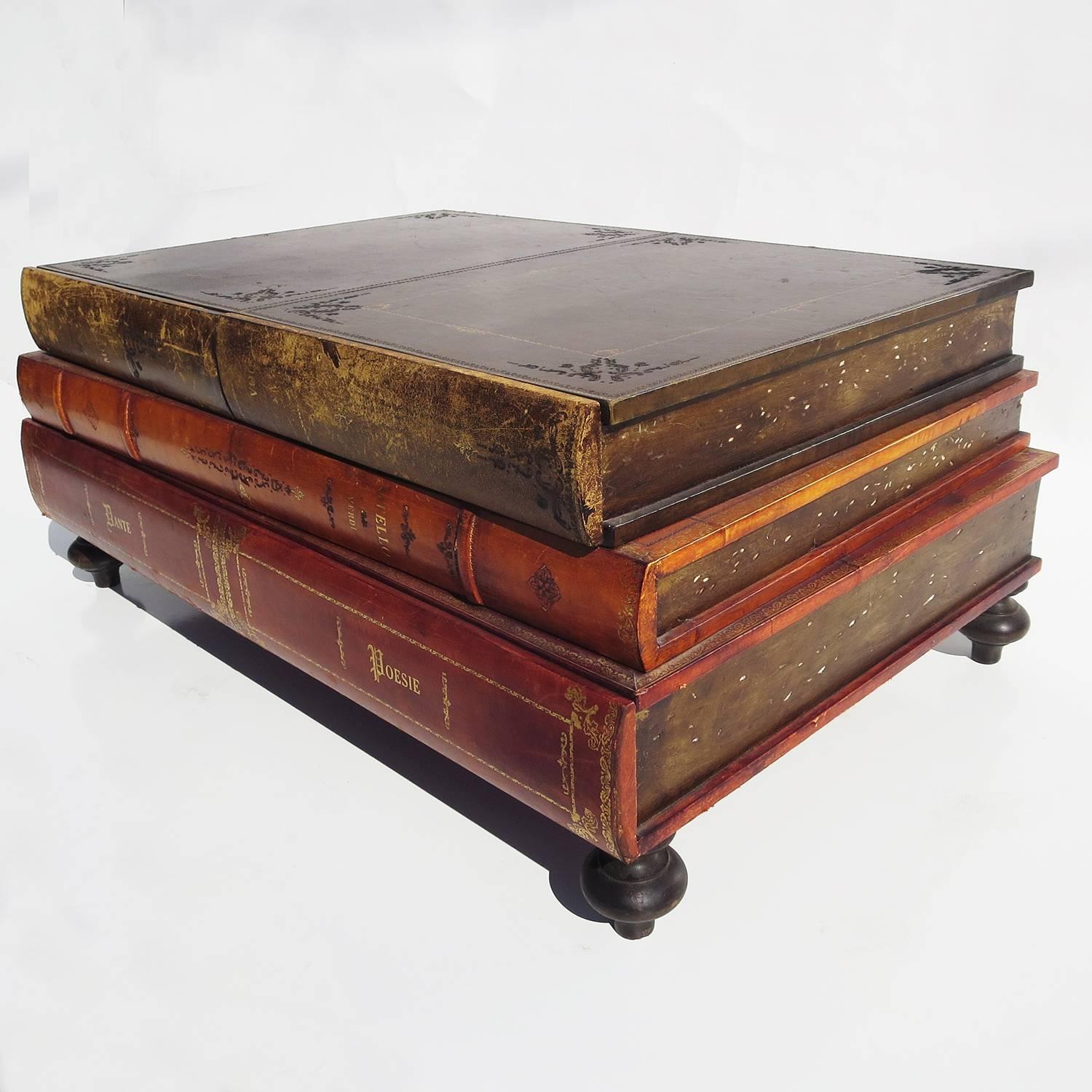 The perfect coffee table for your home library! The stacked books are wrapped in a wonderfully aged leather, with titles like Dante, Otello and Mozart. The top book has two concealed drawers and the bottom book has one long drawer inside. The books