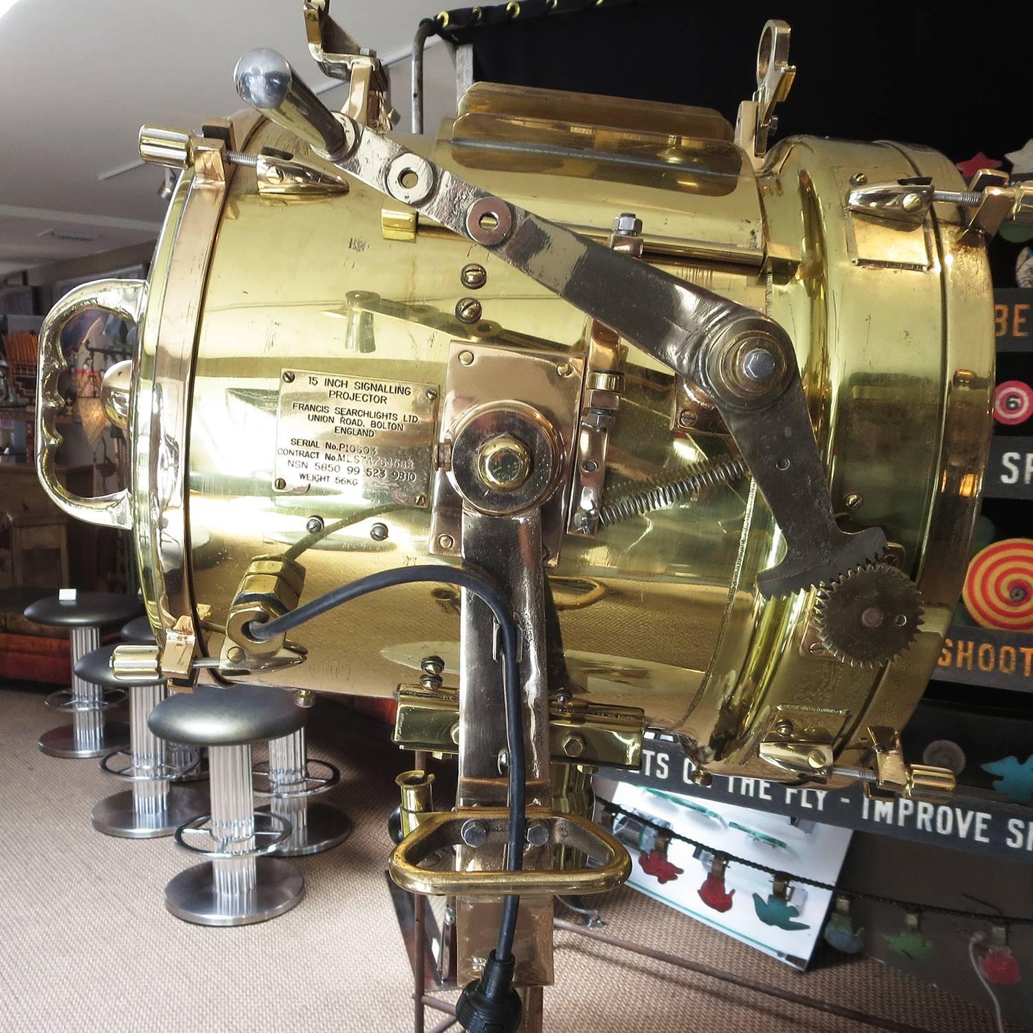 Used on the decks of British naval vessels, this powerful projector would send lighted signals in Morse code. By manually pulling the spring loaded lever arm, one could open the face flaps to send a long 