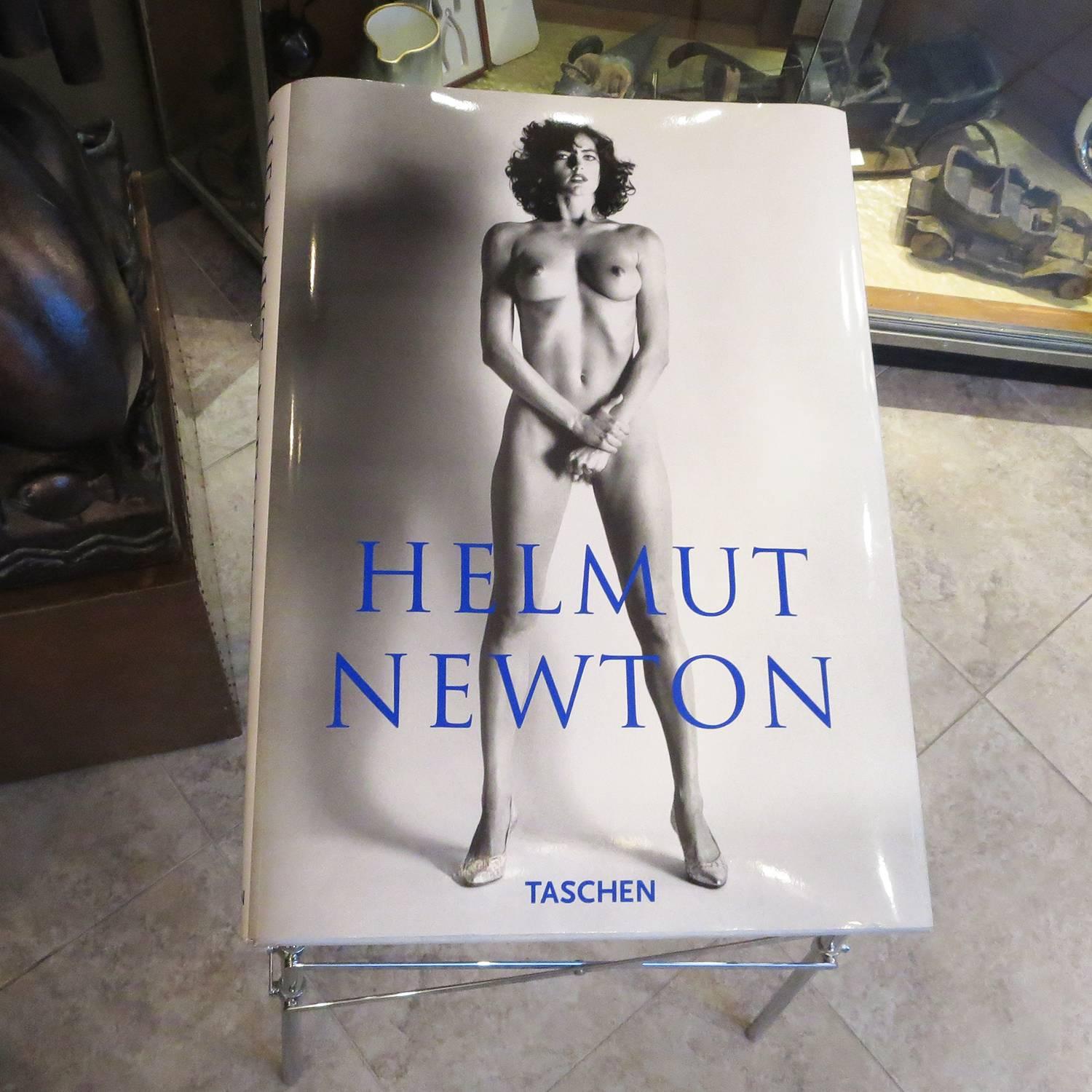 One of the most impressive books ever published! The 464 page, sixty six pound book is one of the largest ever created. Each of the edition was numbered, (ours is 3479 / 10,000) and this copy was hand signed by Helmut Newton. The chrome-plated Stand