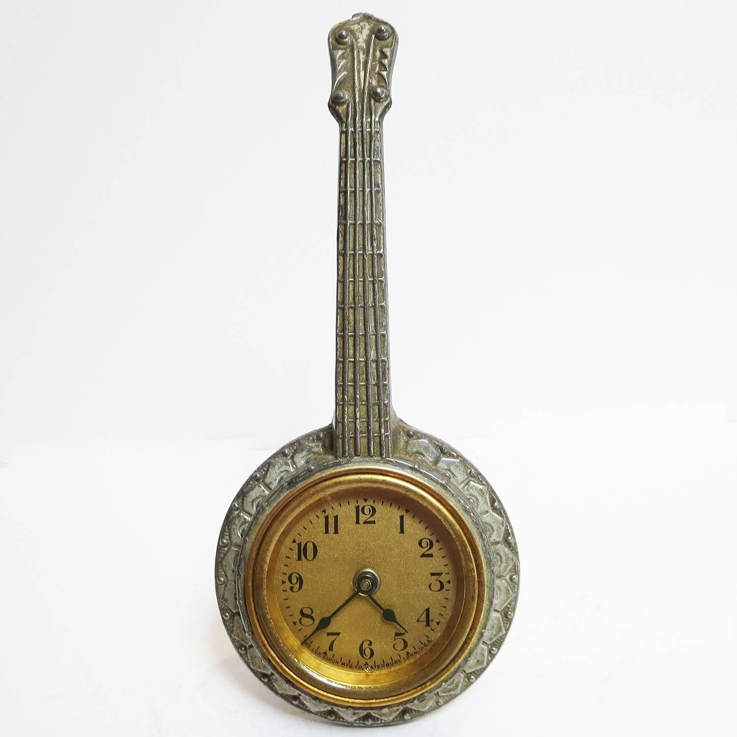 A super charming banjo clock in a cast metal body. The clock is a wind up watch style, and works great. The clock is made by the Lux Clock Mfg. Co. of Waterbury Conn., and the body is marked Viking E W N. Y. The painted finish shows overall wear of