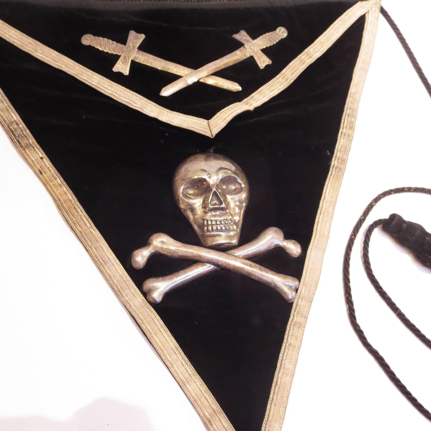 Dating from the late 1800's, this black velvet apron was worn by the Knights Templar of the Masonic fraternity for ceremonial meetings. The apron is all original, and in very nice condition, including the sterling silver skull, crossbones, and
