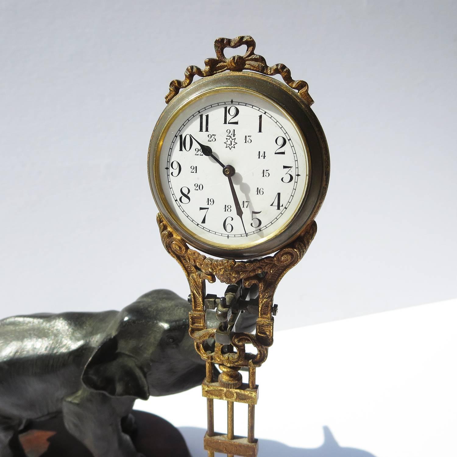 This fantastic clock attests to the European fascination with all things African. The cast bronze elephant is in full trumpeting mode, with upraised trunk and opened mouth. The clock, trimmed in decorative ormolu, gently swings back and forth, in