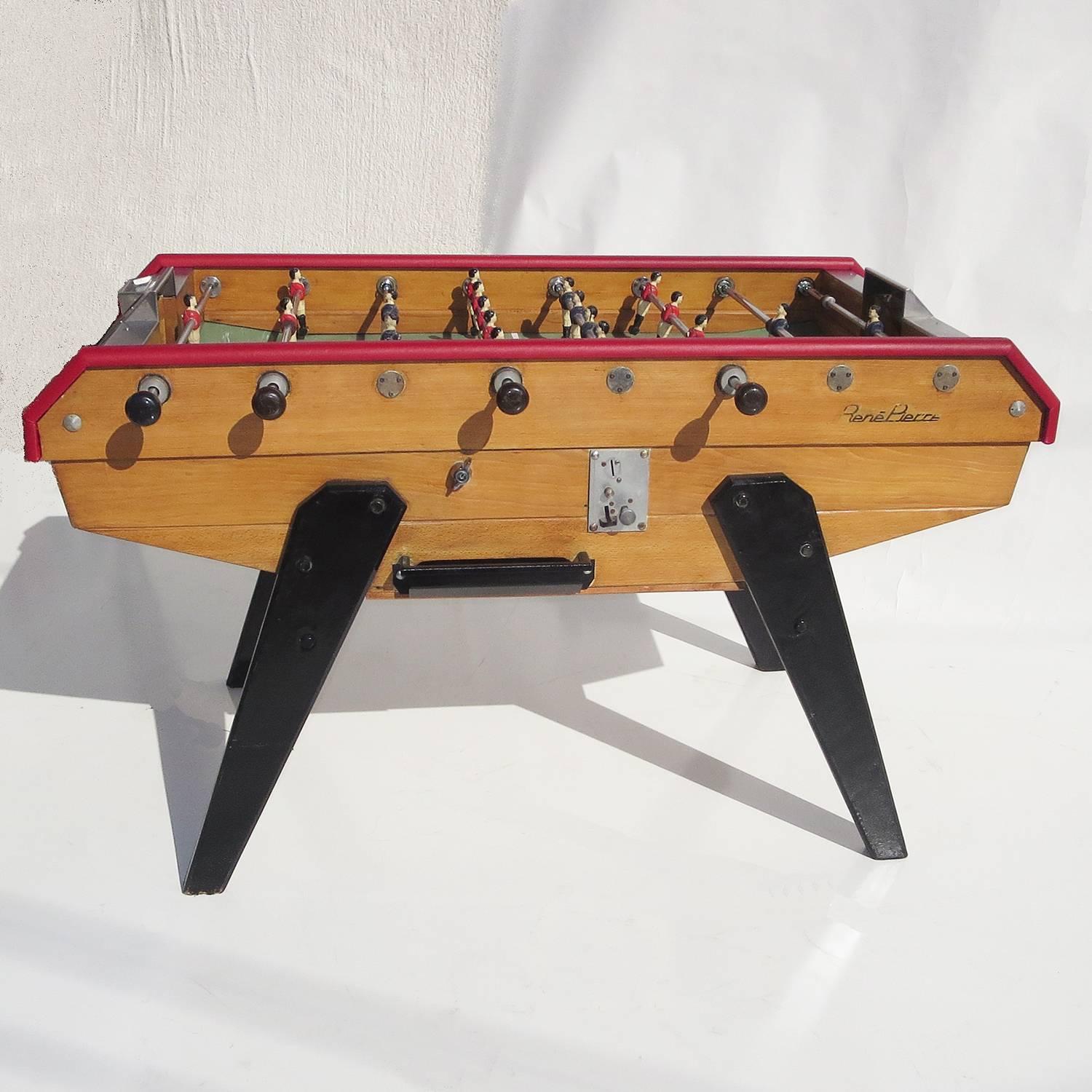 With the worldwide popularity of soccer, or football, these tavern sized Foosball tables have become increasingly popular. Ours is an earlier version, with wooden cabinet and painted wooden legs. It has been adjusted to free play, so coins are not