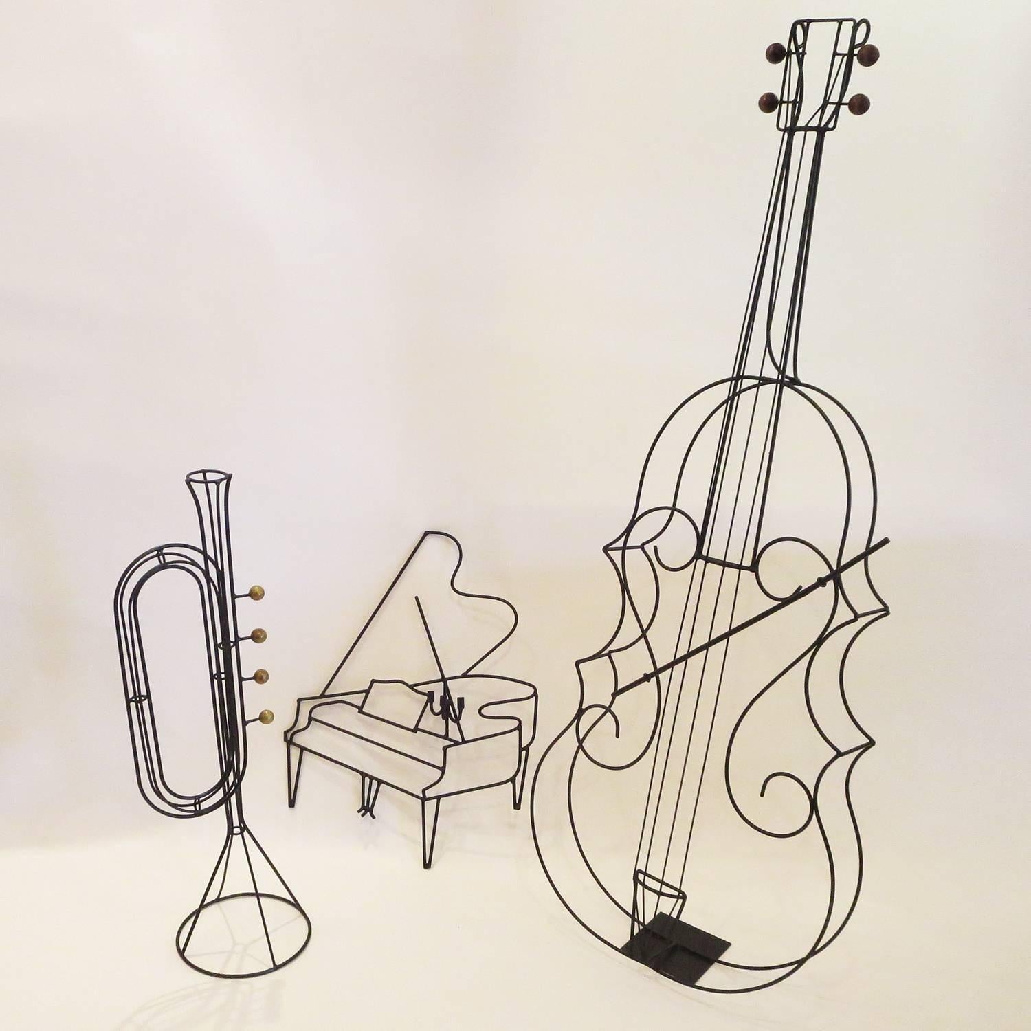 Jazz up your room with this great collection of instruments by the master of wire Frederick Weinberg. The grand piano measures 20 inches wide and is 26 inches tall. It has holders for three candles and would mount to the wall. The trumpet and