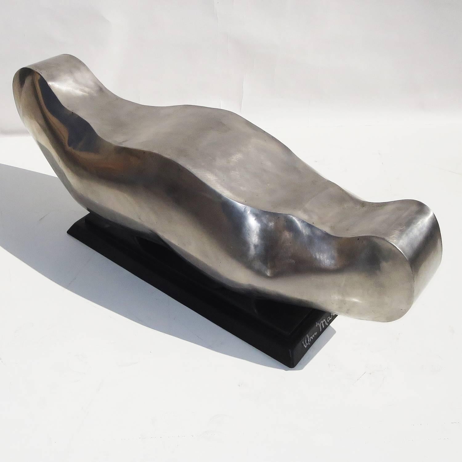 A dynamic form by California sculptor / artist William Martin. The form is hollow steel panels, welded, polished and clear lacquered. The base is black painted steel, with a raised signature. The inside is also weld signed Bill Martin 75. The