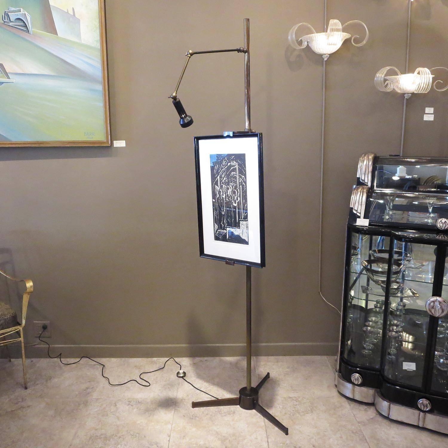 A very fine example of the iconic easel by Angelo Lelli of Italy. The easel lamp retains original Arredoluce label to the underside. The lamp has multiple adjustments to direct the light to any size artwork. Each support arm for the artwork are also