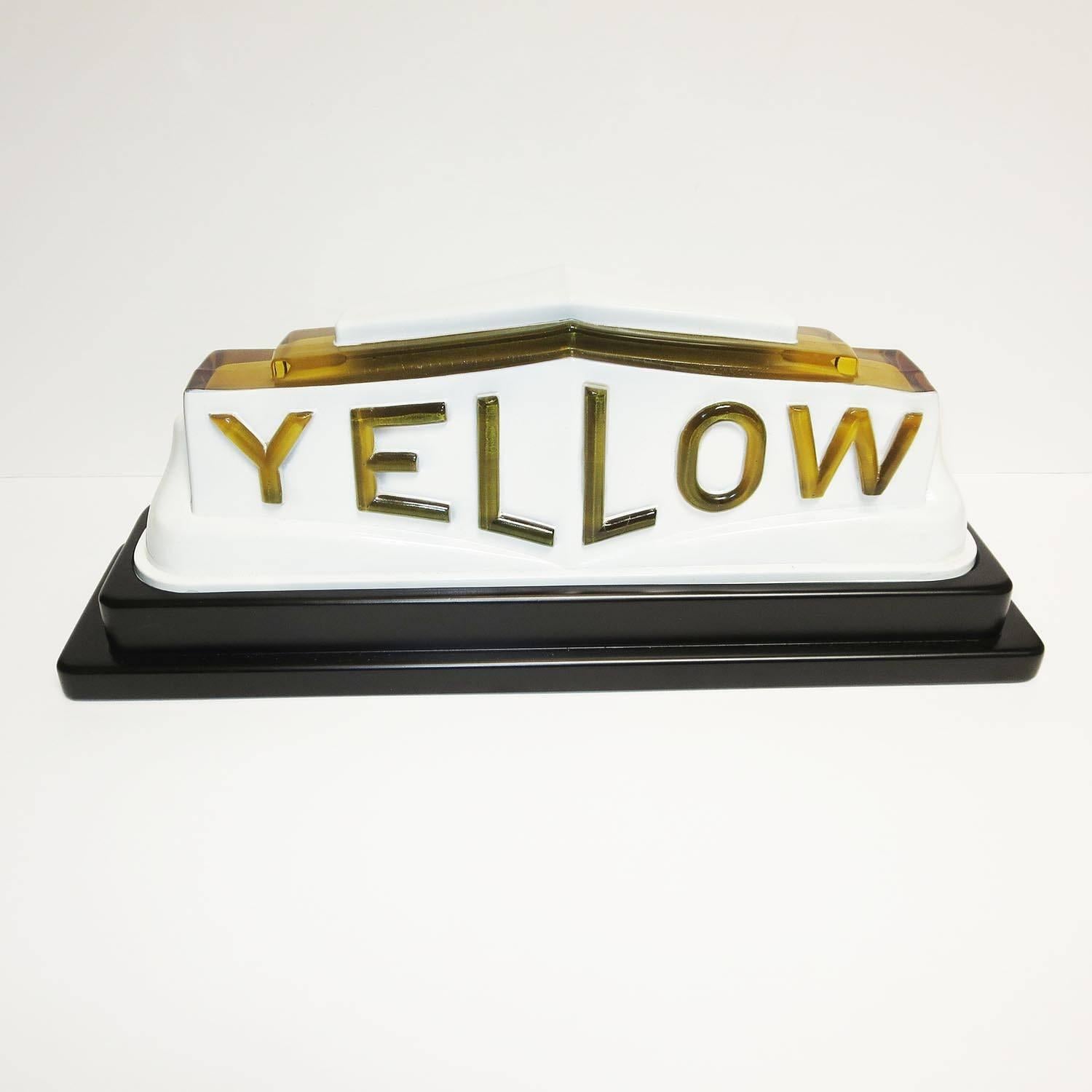 This rare and wonderful lighted sign mounted on top of a 1930s Yellow cab. It is one piece molded glass, with original baked enameling. We have created a satin lacquered wooden base with lights inside for display. These are extremely difficult to