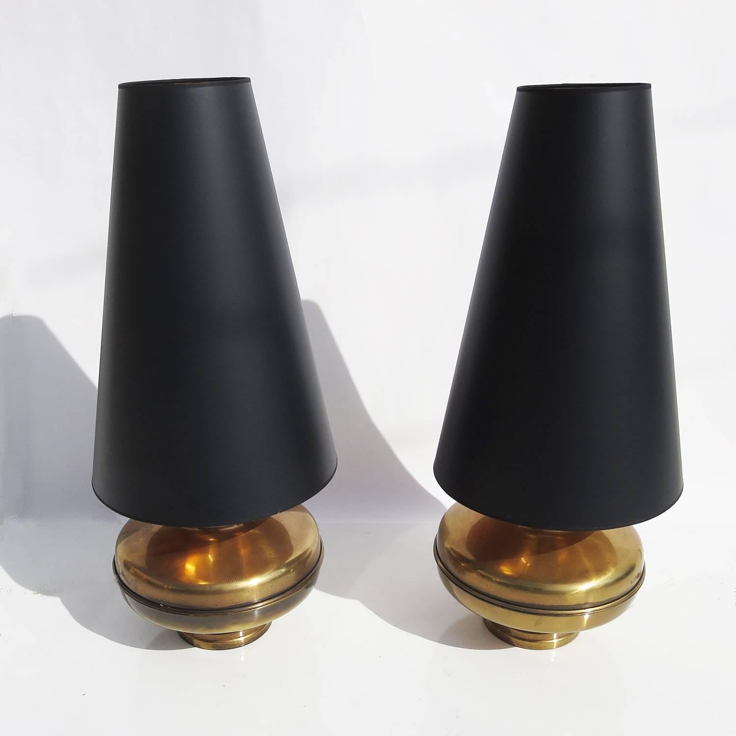 This great pair of lamps will certainly make a statement in any room. The bases are lacquered antique brass in nice original condition. The shades were custom-made by us in a satin black paper with a gold foil interior. The lighting is a standard