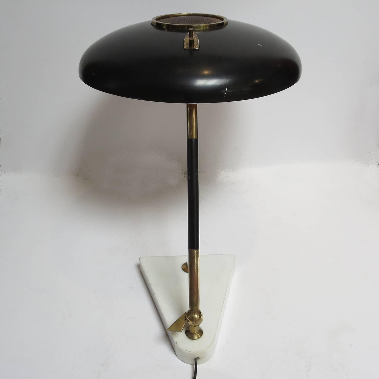 Fine and rare example of Oscar Torlasco's desk lamp for Lumi of Italy. The lamp is in nice working original condition. There are a few minor scratches to the paint on the shade, but we have opted to leave as original. However, we will be happy to