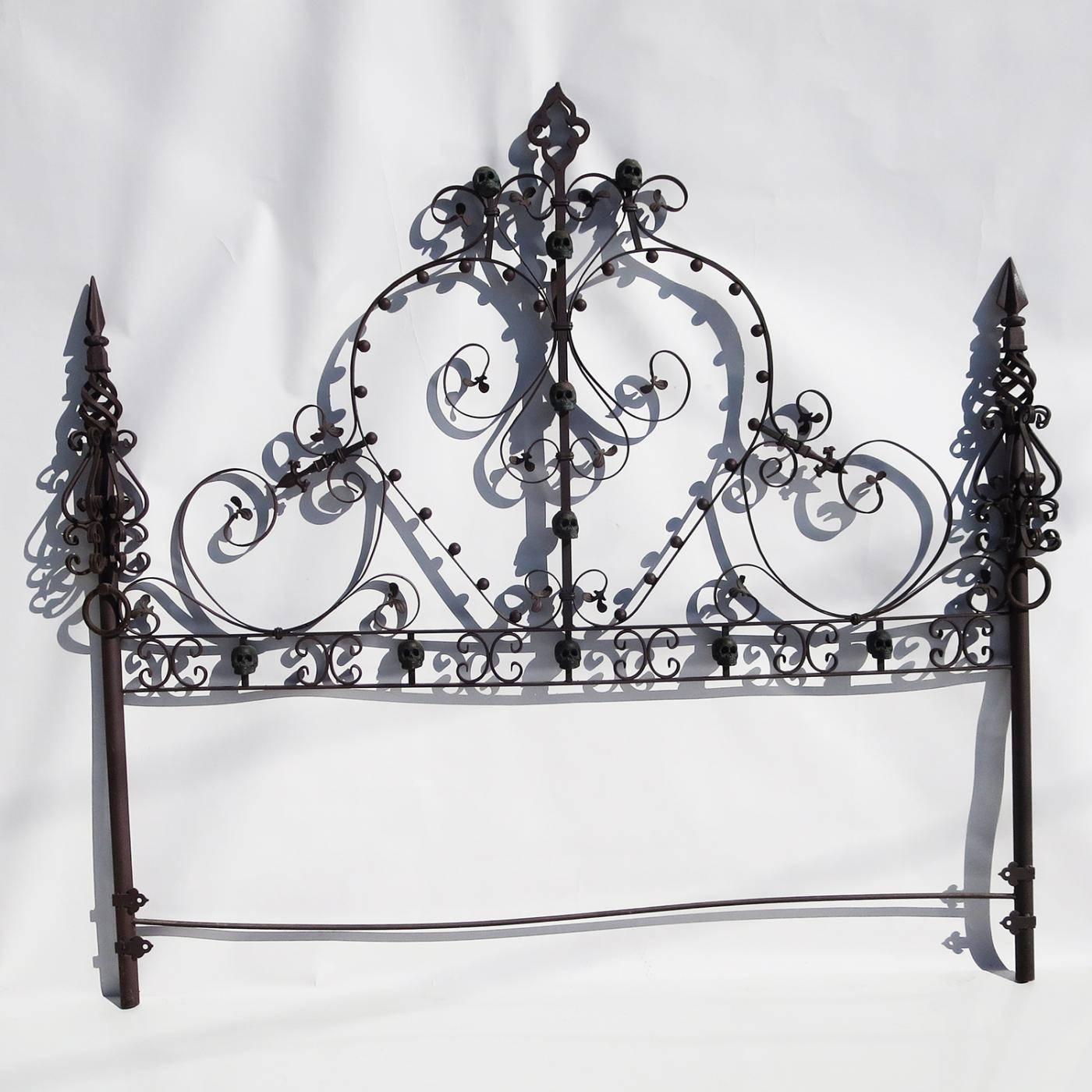 RETIREMENT SALE!!!  EVERYTHING MUST GO - CHECK OUT OUR OTHER ITEMS.				

A wonderfully crafted headboard and footboard in elaborate wrought iron, in a king-size. The bed features a motif of green patinated bronze skulls on both pieces. There are
