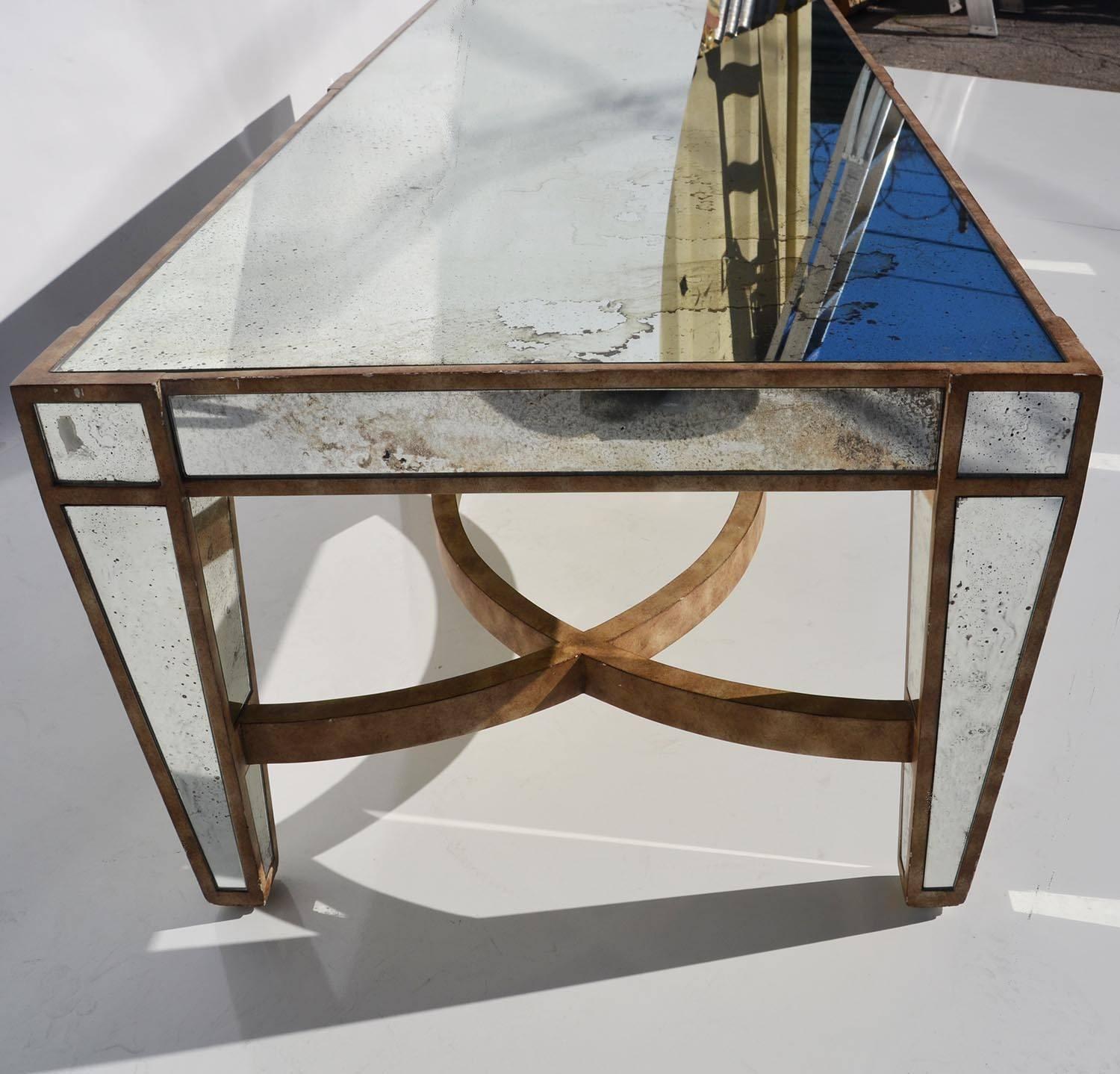 This impressive table is made of multiple panels of aged mirror, set into a painted wood table. The overall condition is quite nice, with natural intended aging.