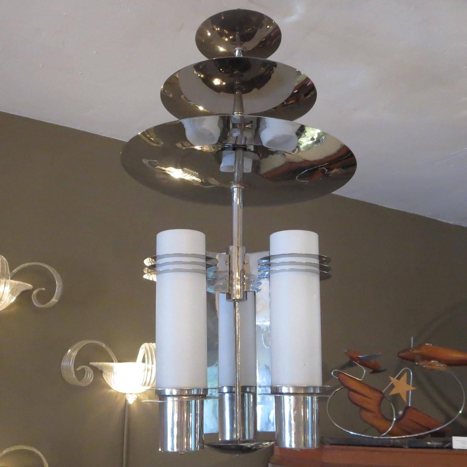 An incredibly stylized lamp that would have been found in a 1930s theatre or skyscraper lobby. The lamp has been re-plated and rewired, and looks terrific. The top disc slides down for ceiling mounting, then raises up to cover the ceiling mount.