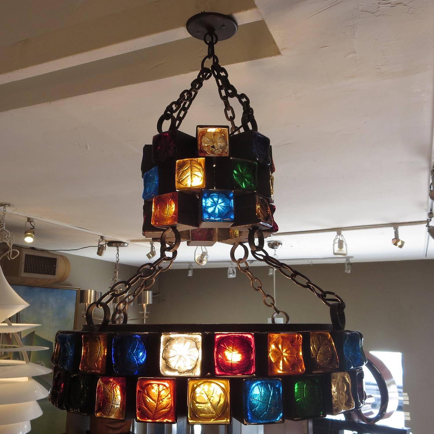 This fantastic lamp was designed by Feder of Mexico, circa 1960s. Each of the 69 steel cubes houses a colored molded glass face with an impressed leaf pattern. This is the largest and most elaborate chandelier we have encountered from the company.