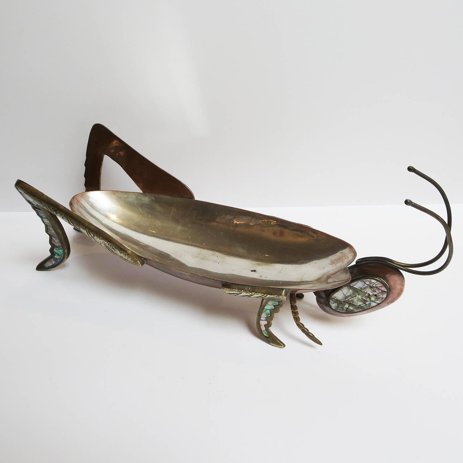 A lovely decorative bowl for candies or any small items. The body is made from copper, with a silver plated centre lining. The legs are solid brass, with abalone inlay. The head is made of copper, with abalone inlay. The bowl is marked Cobre