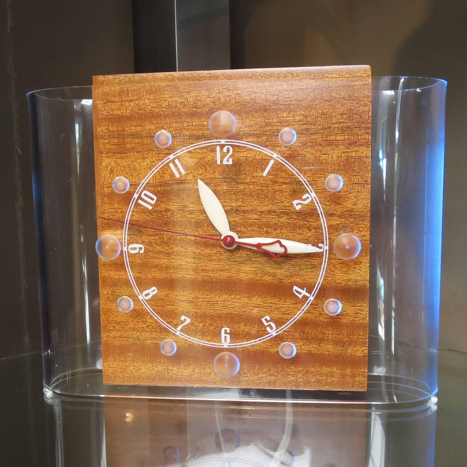 Best known for large exterior neon signs and clocks, the Lackner company also offered a short lived line of neon clocks for the home. They featured cases in catalin, bakelite, and wood, with Lucite accents. Ours is referred to as a 