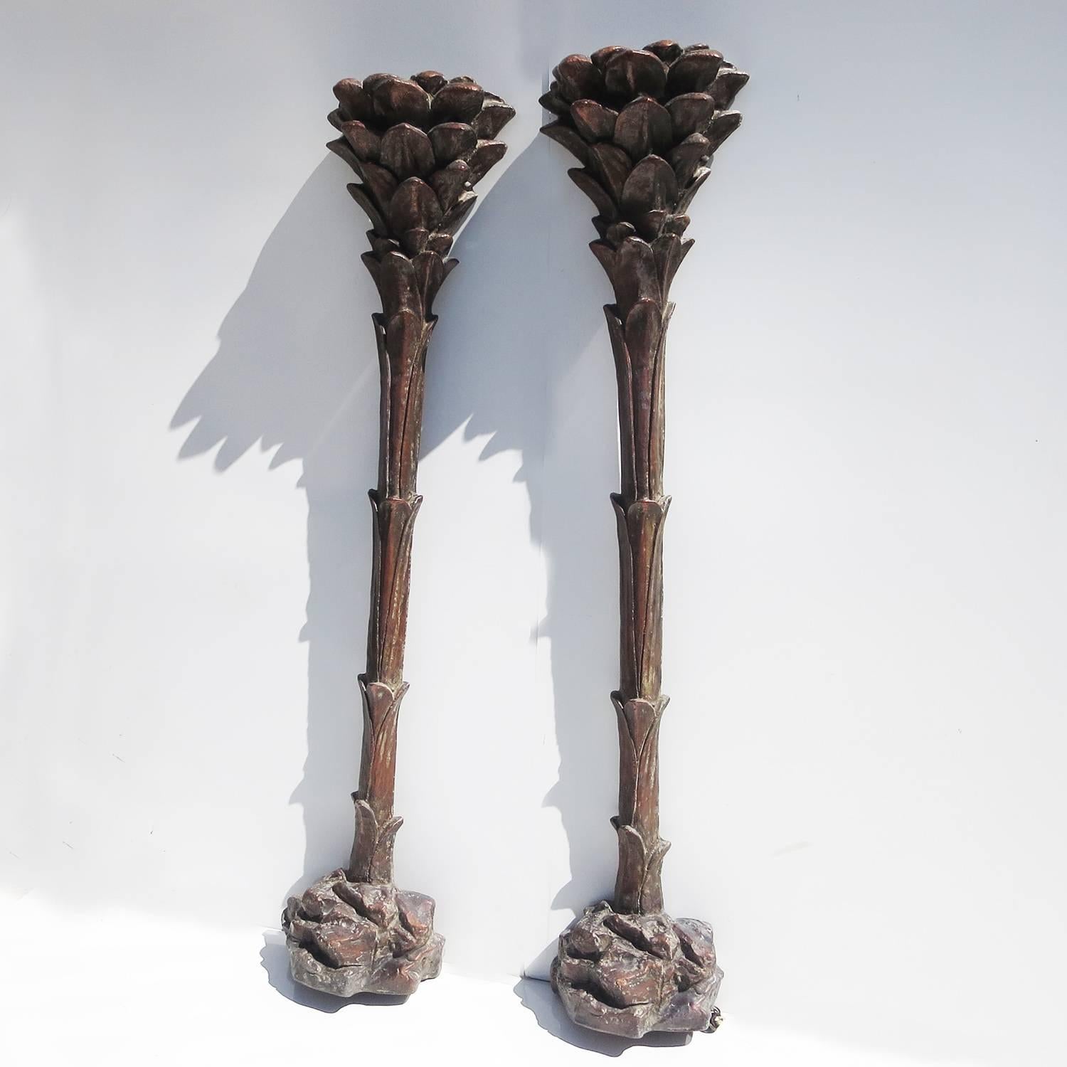 A great pair of period palm tree torchère lamps without the big Serge Roche price! The pair are finished in a dark coppery bronze coating, and look fantastic and aged. The bodies are made of a polystyrene foam, so they are strong without being too