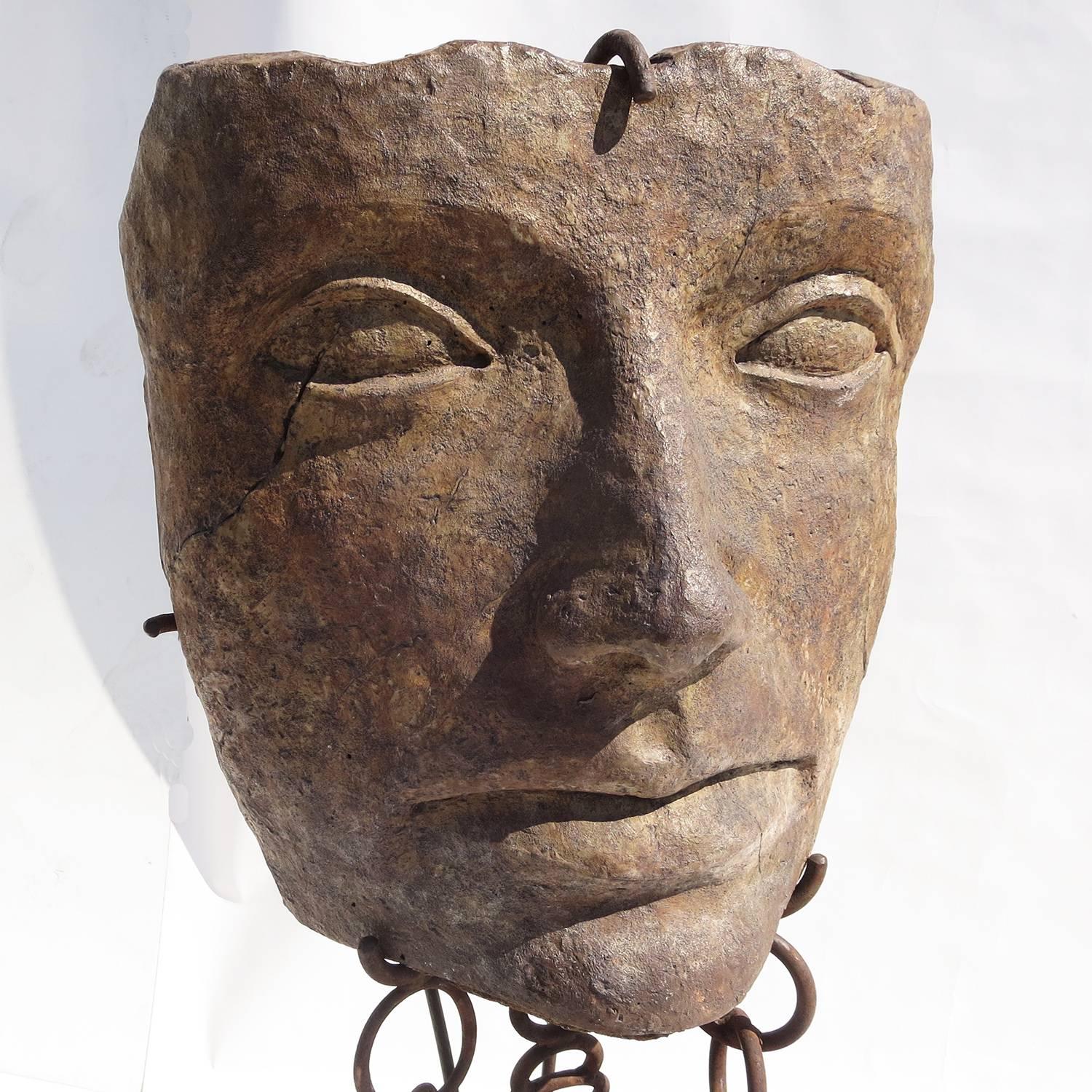 This amazing sculpture seems to have been retrieved from the depths of the ocean, suspended in mid air by heavy chains. The head, by an unknown artist, is a sculpted and glazed ceramic material, resembling carved stone. There is a hallmark stamp by