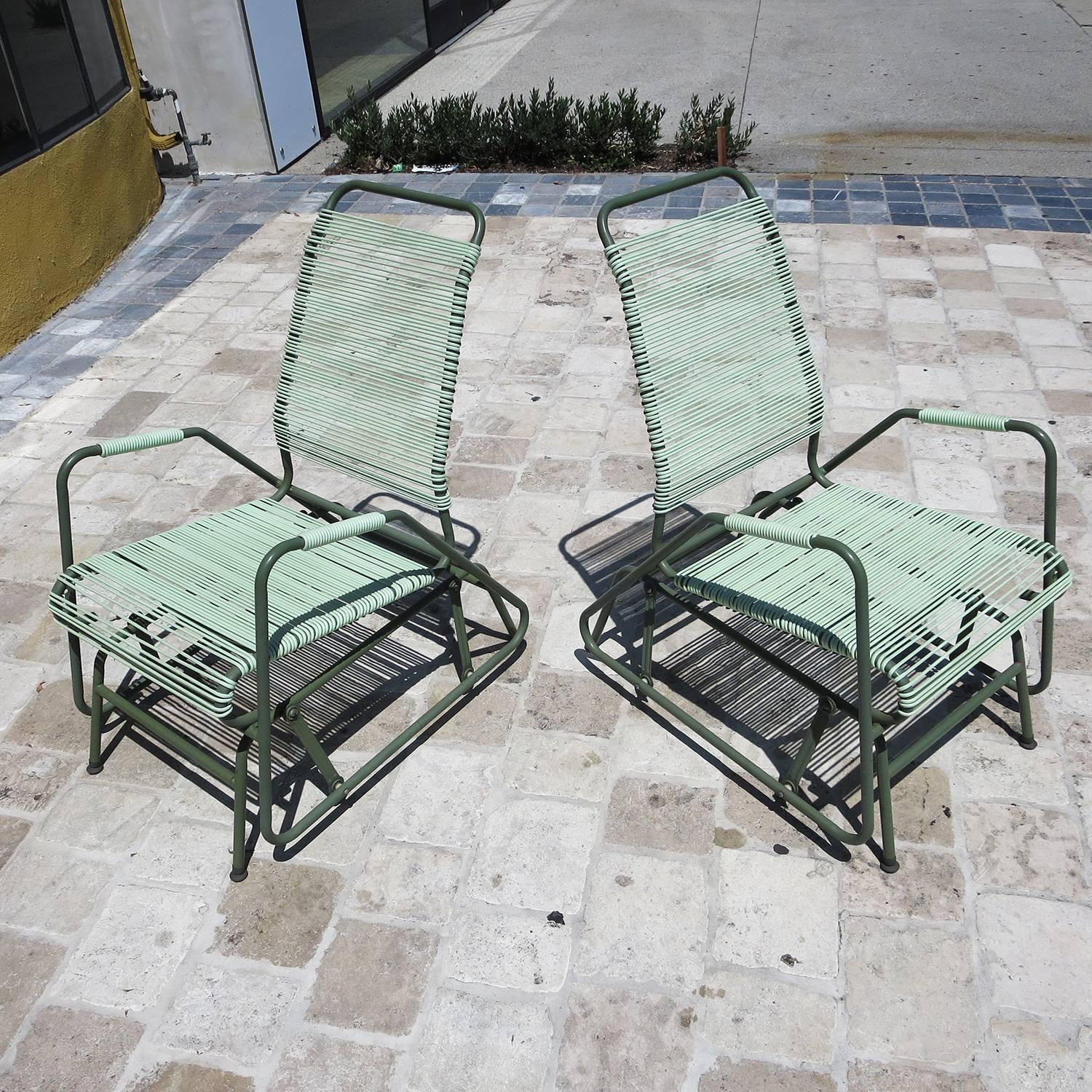 This great pair are incredibly comfortable, and in amazing original condition. The mint colored rubberized webbing is supple and unbroken, and the painted frames are very clean. The chairs glide forward and back smoothly, and they look terrific.