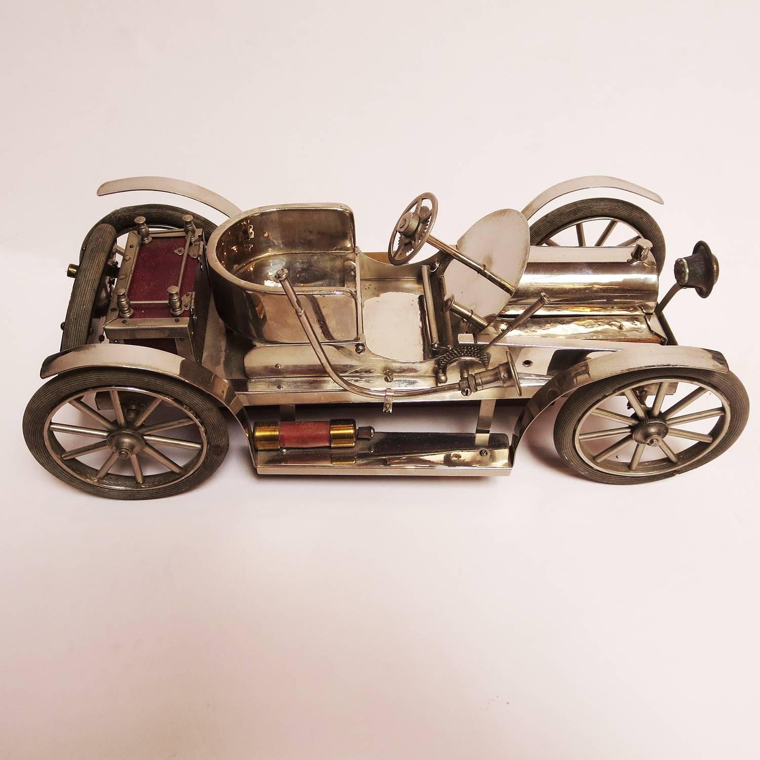 This fantastic desk top car model represents a circa 1910 early automobile, although it is unknown when this example was built. The model is greatly detailed and well-constructed. All metals are "German silver" plate over brass, as well as