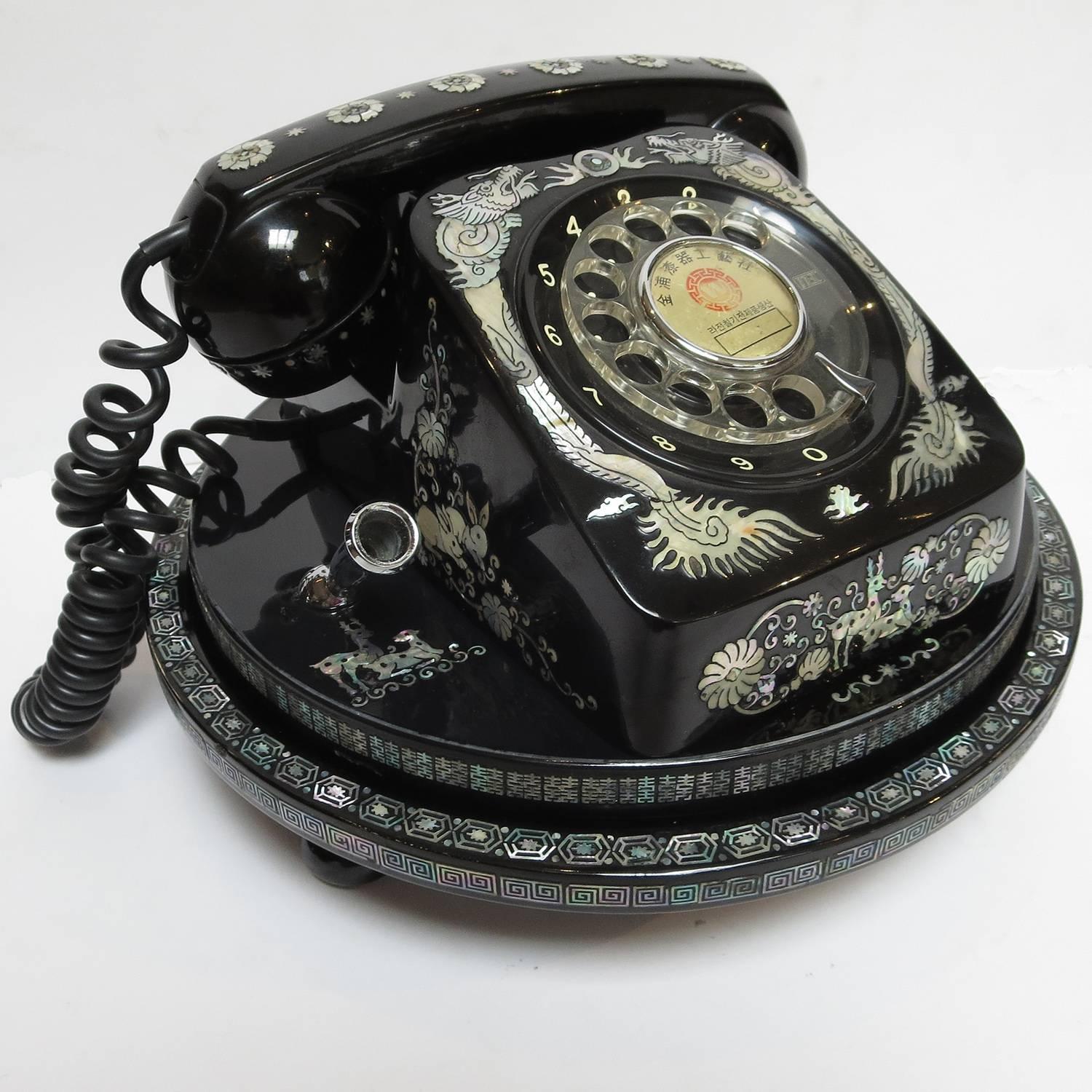 This certainly has to rank as one of the more outrageous telephones we have ever encountered! The working dial telephone is incredibly decorated with mother-of-pearl dragons, deer, rabbits, and other floral and geometric designs. The telephone sits