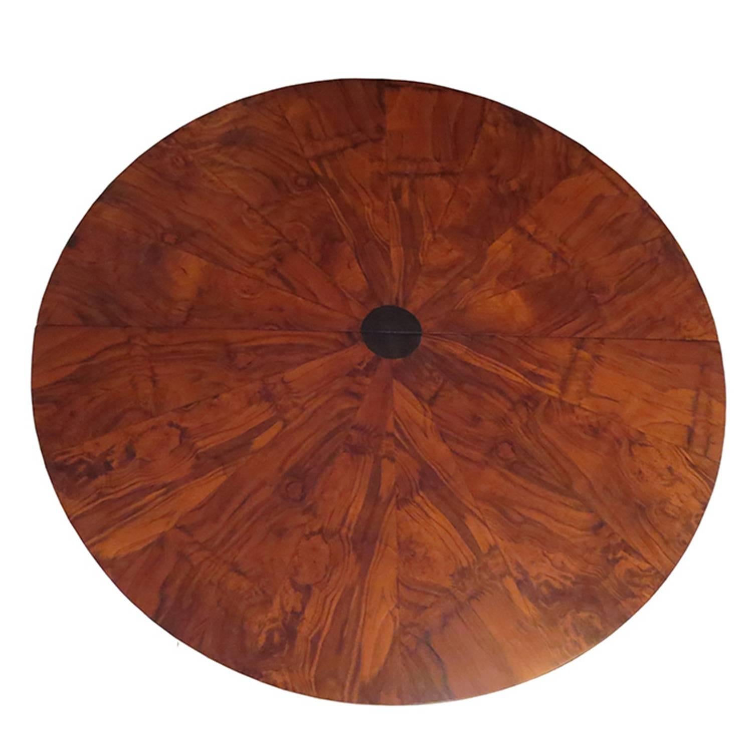 This incredible dining table was designed by Paul Evans in the 1970s as part of the “Cityscape” line. The top is a highly figured burled wood grain in a sunburst pattern with an ebonized circular center. With the extension in place, the center