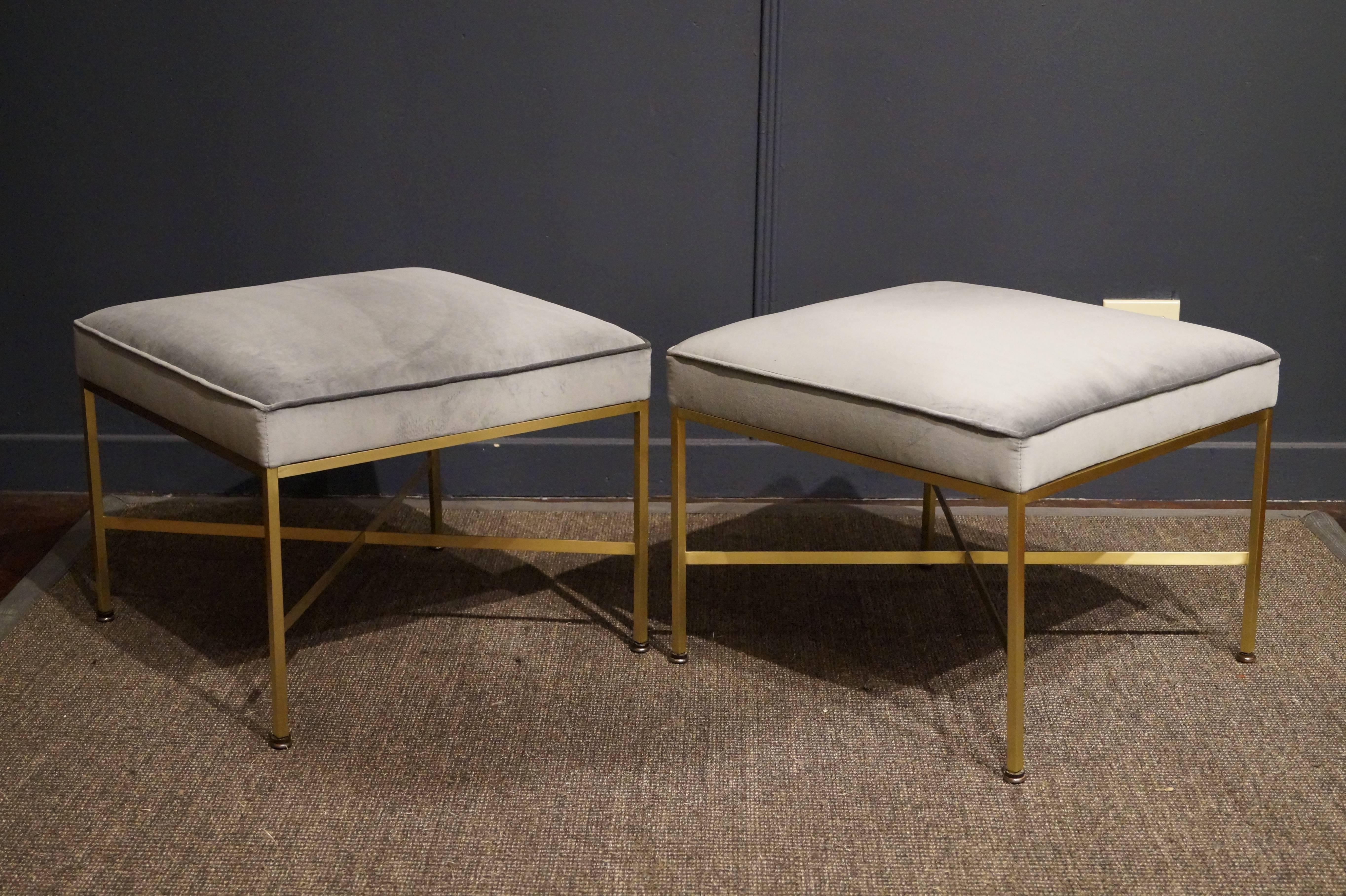 Pair of Paul McCobb design ottomans in polished brass and new ice blue velvet.