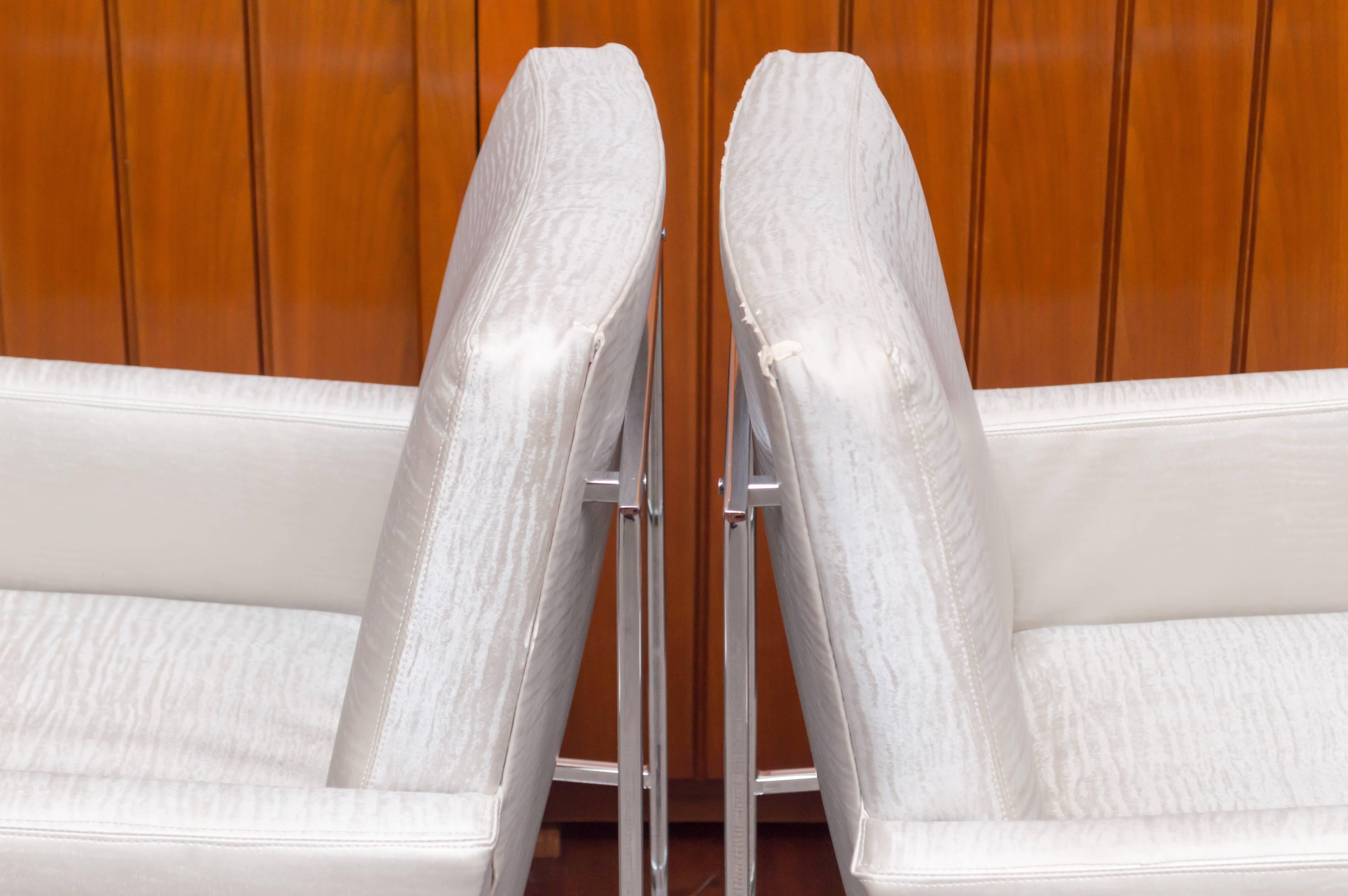 Pair of Milo Baughman design chrome and upholstered armchairs for Thayer Coggin. These chairs can be used as head chairs at a dining table or in a living room setting.