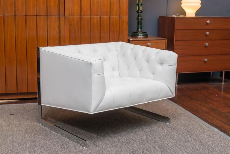 Stylish and comfortable design lounge chair. Newly upholstered in Italian white leather on a cantilevered chrome flat bar frame.