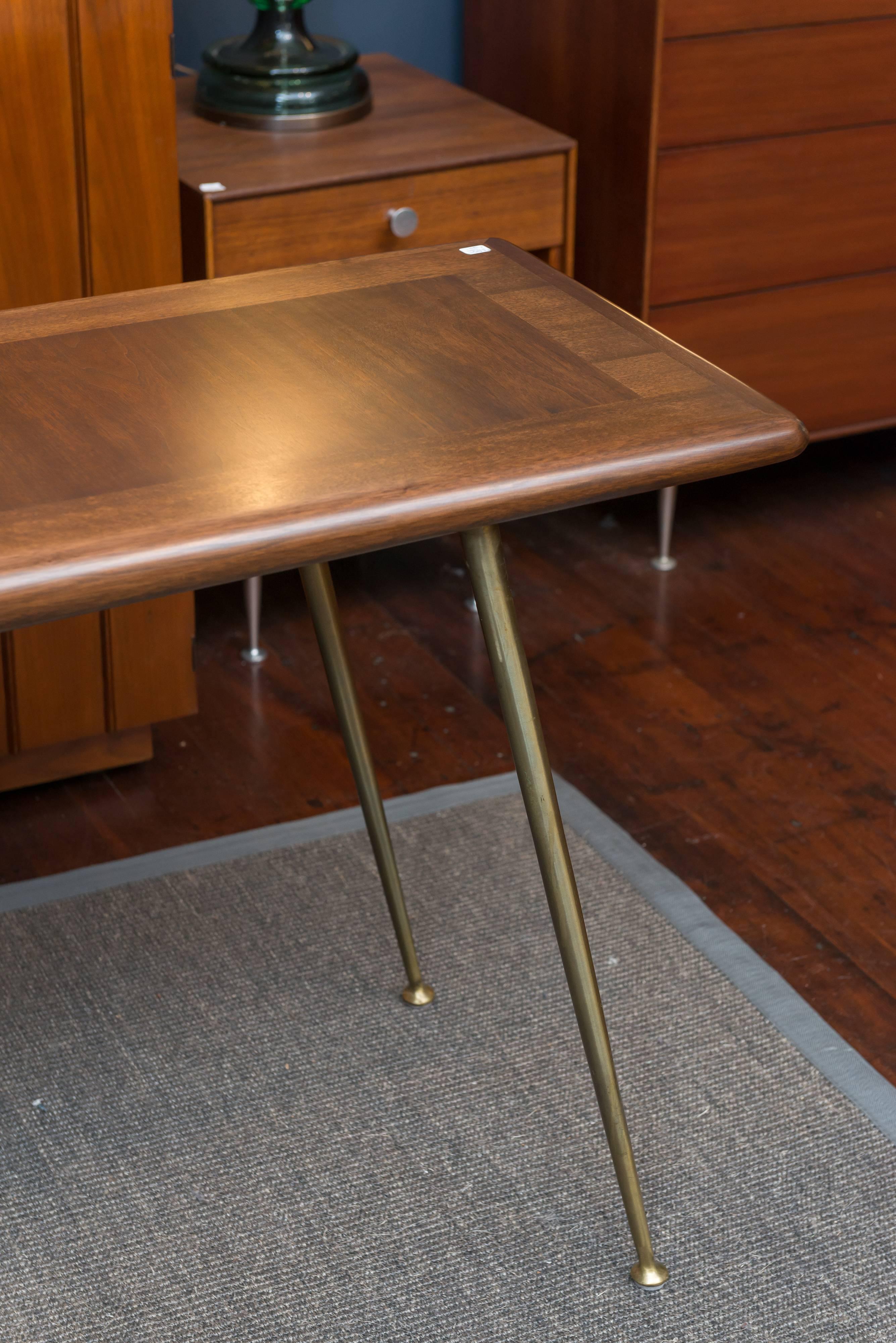 Elegant and refined design by T.H. Robsjohn-Gibbings for Widdicomb Furniture Co. Made from mahogany with bull nose borders on tapering solid brass legs. Perfectly refinished top, labeled.