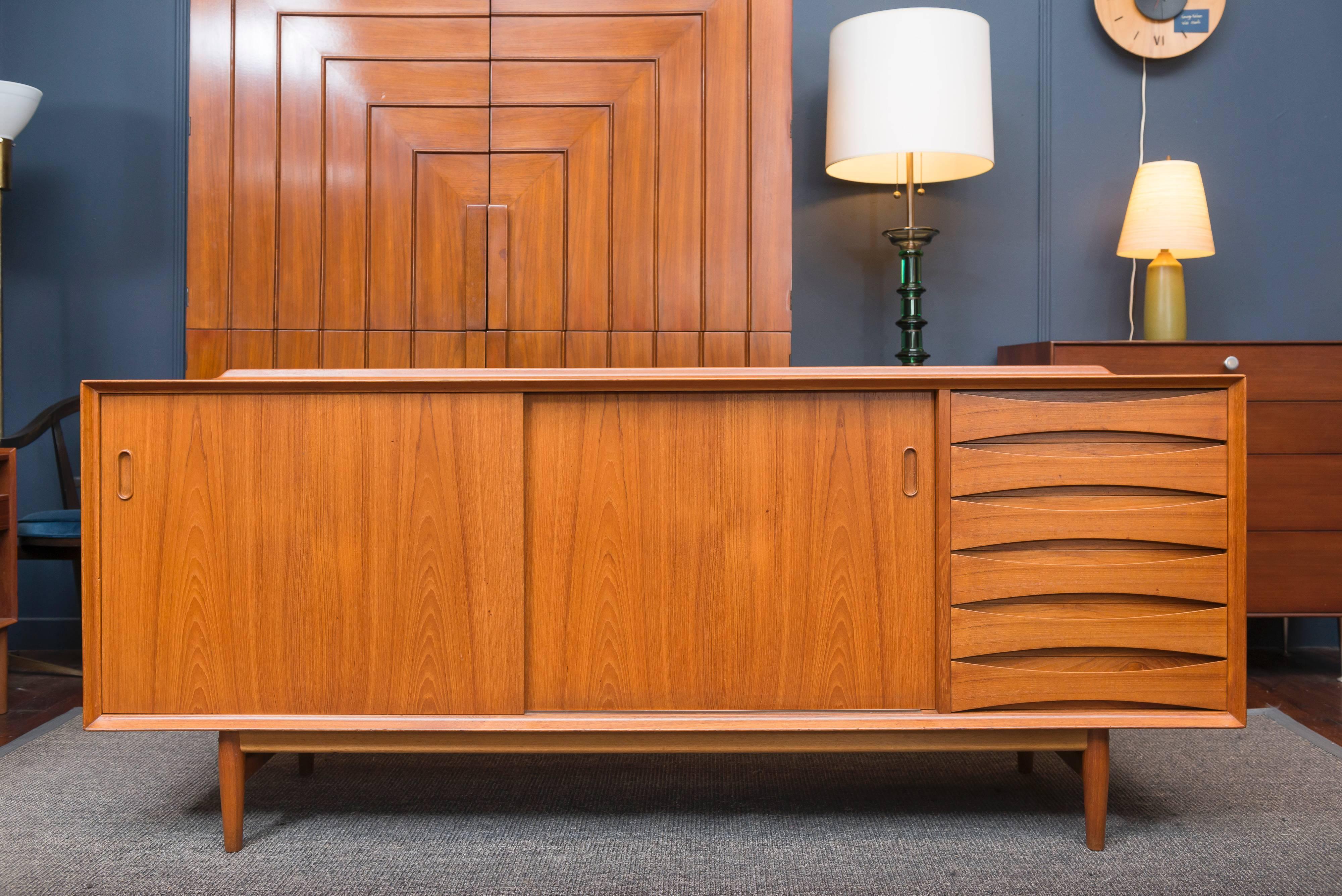 Timeless design and quality construction exhibited in this teak credenza by Arne Vodder for Sibast Furniture co. Perfectly refinished with adjustable shelves.