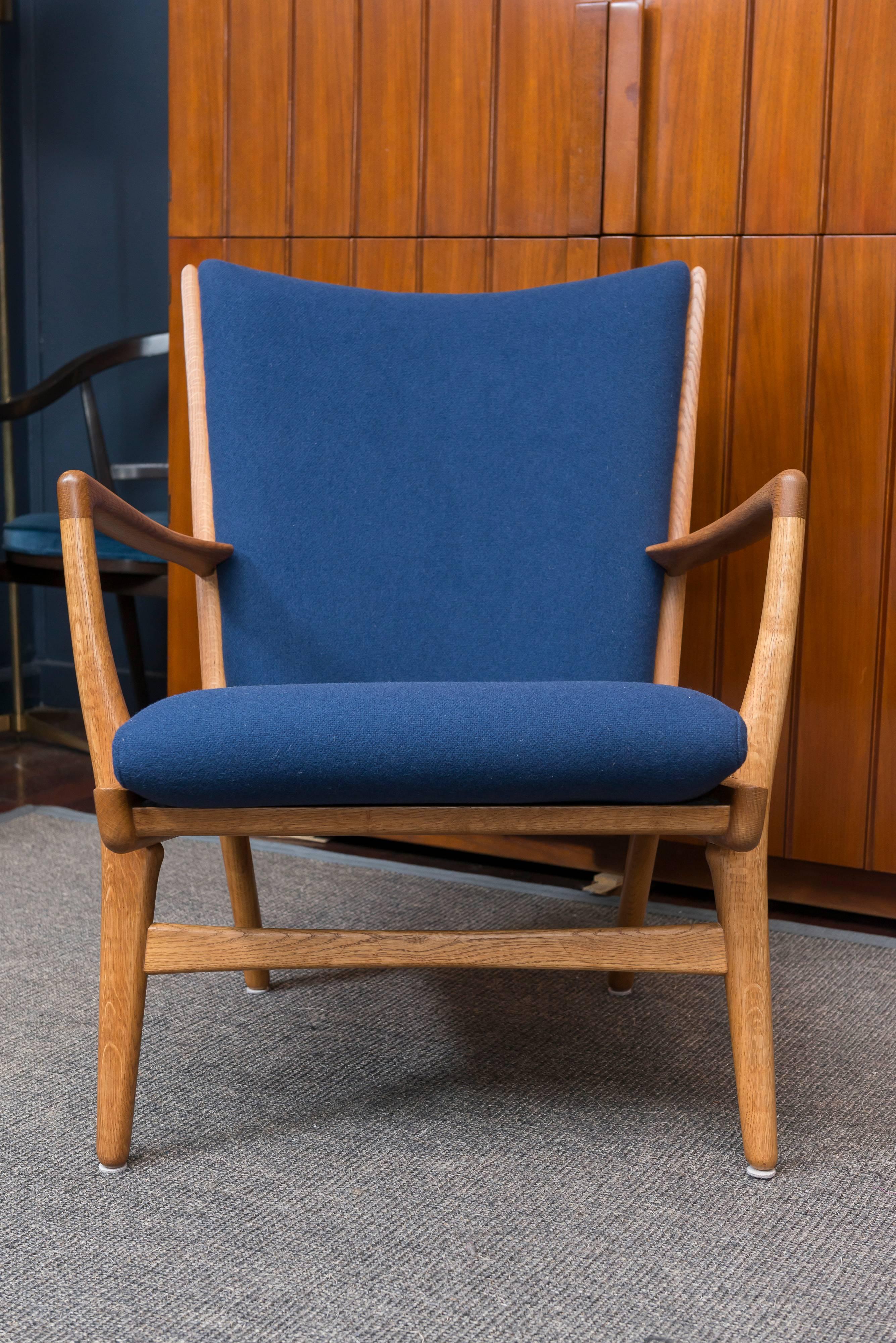 Hans J Wegner design oak and teak lounge chair, model AP 16 stolen, Denmark. Perfectly refinished and newly upholstered.
