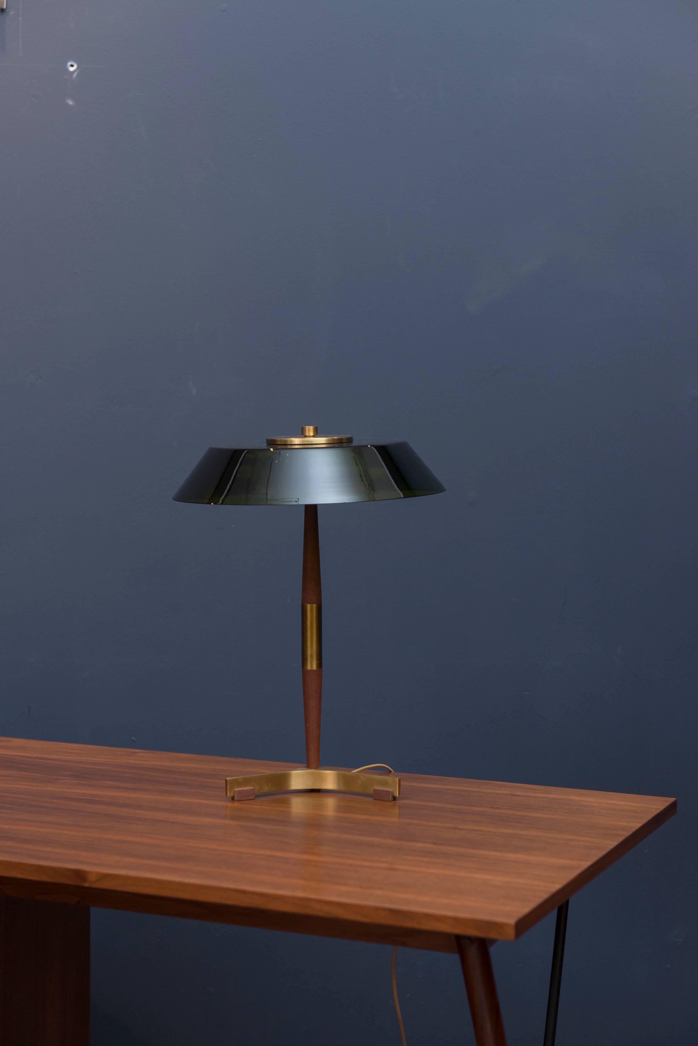 Fog & Mørup manufactured table lamp made from teak and brass with a green glass shade. Three or four flea size chips to glass shade edge.