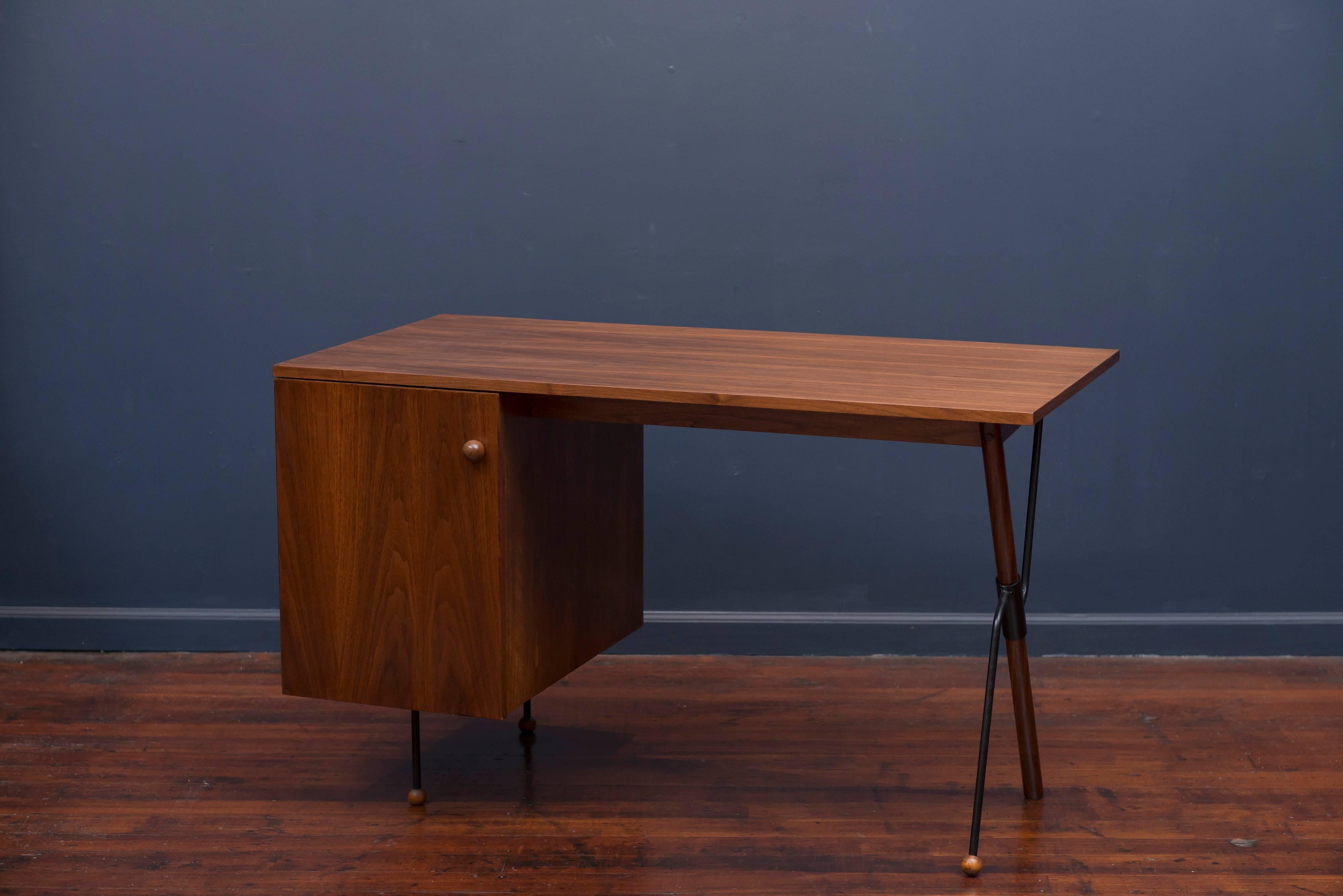 Greta Grossman designed desk for Glenn Furniture Company. Walnut case has been professionally refinished and the metal supports and legs remain in very good original condition. Desk is missing the interior pencil and file drawers.