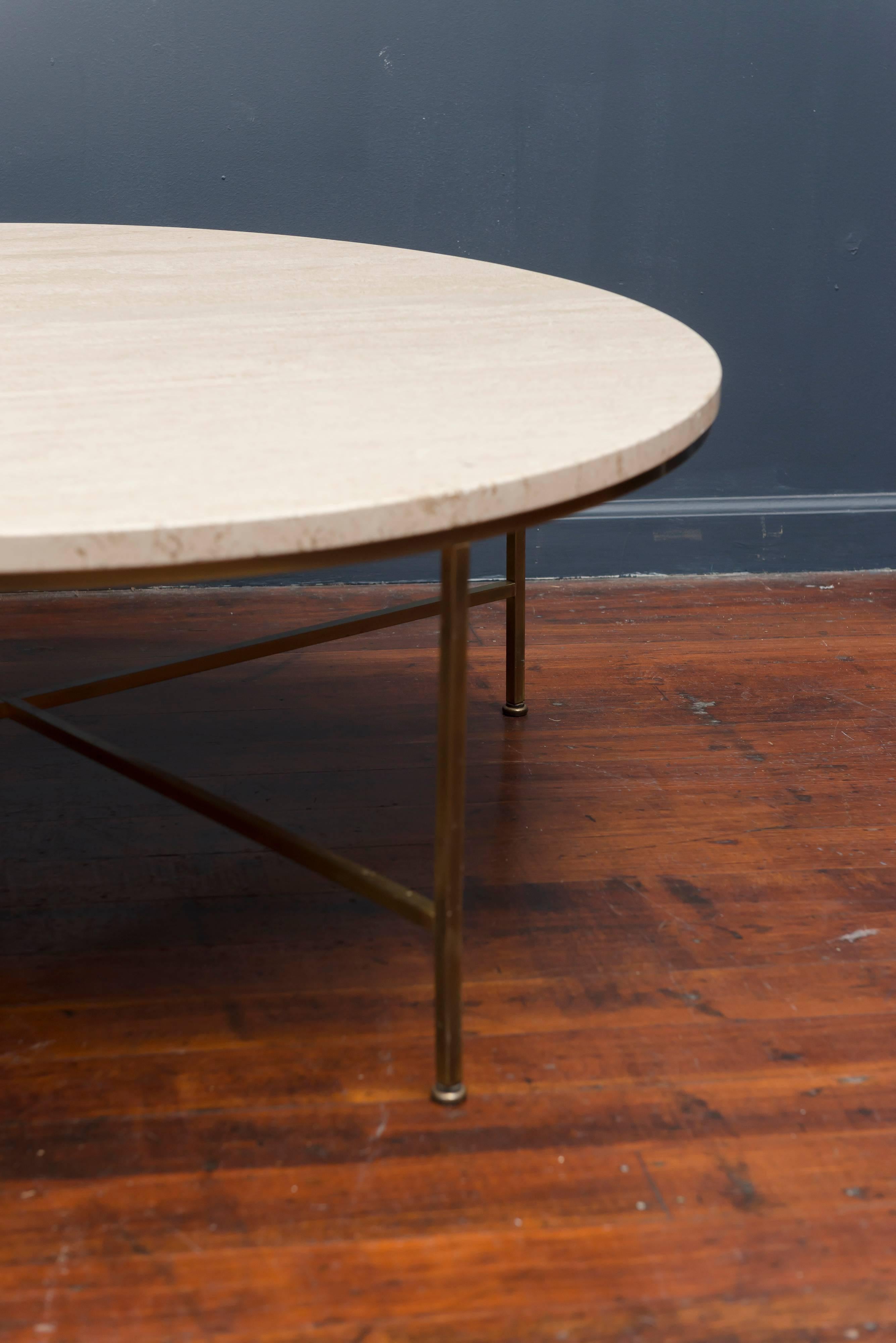 Elegant design coffee table by Paul McCobb for Calvin Furniture Co. round travertine top supported on a patinated brass frame.